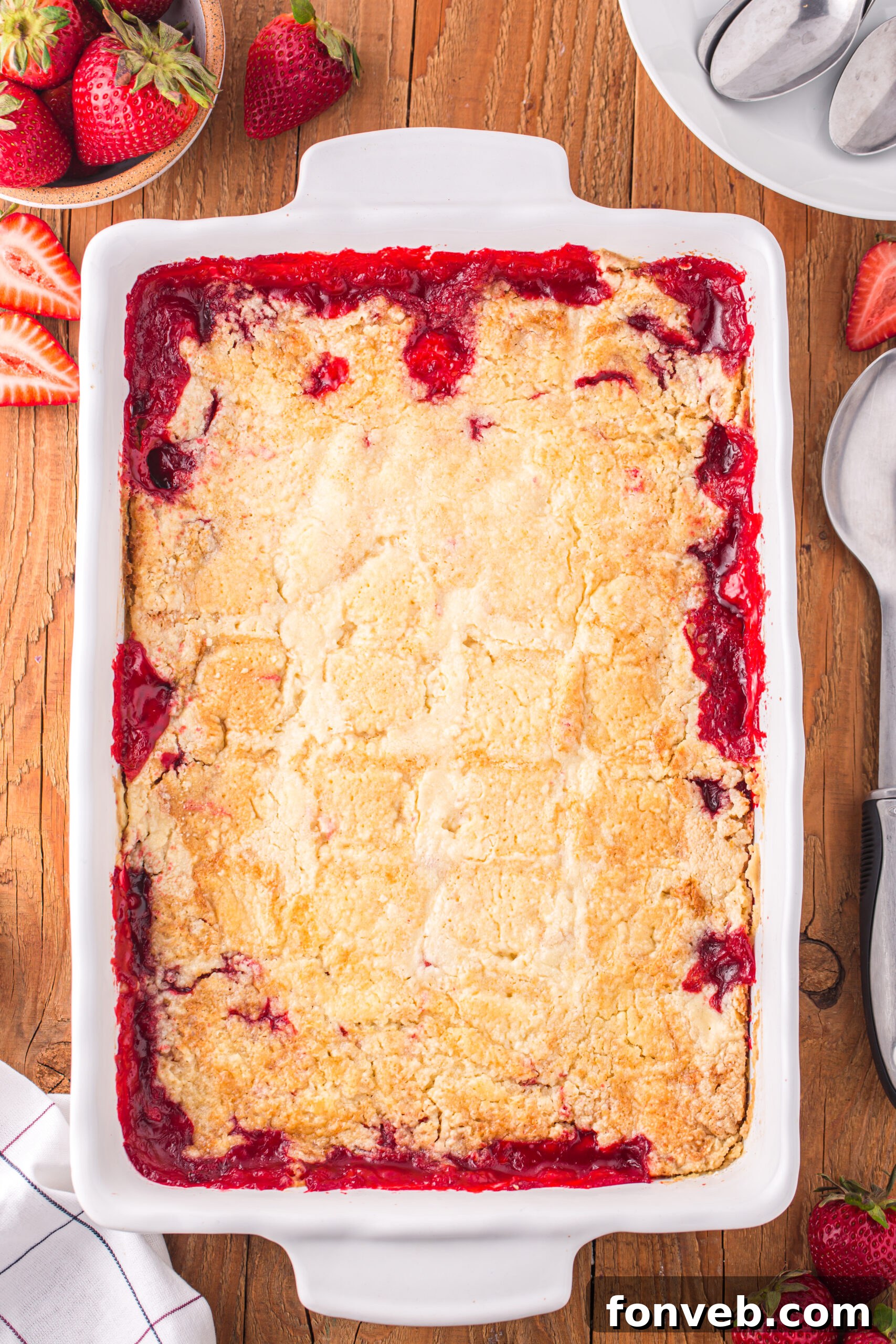 Overhead view of Strawberry Dump Cake in a white baking dish.