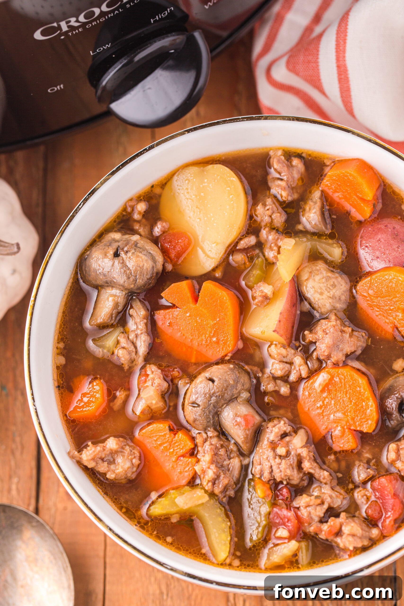 Overhead view of a finished serving of Witches Brew Stew in a bowl with a spoon.