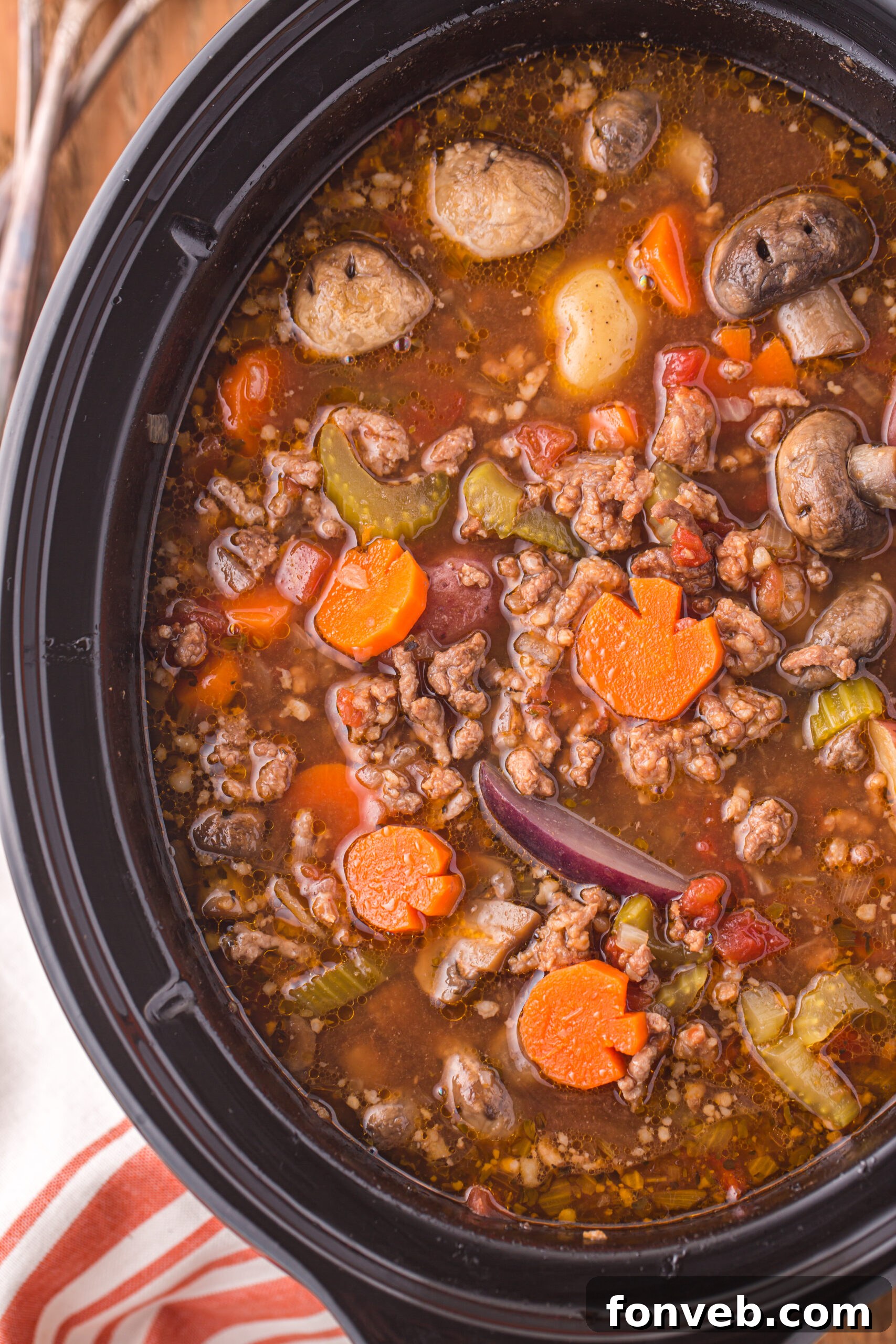 Overhead view close up of Witches Brew Stew simmering in a slow cooker.