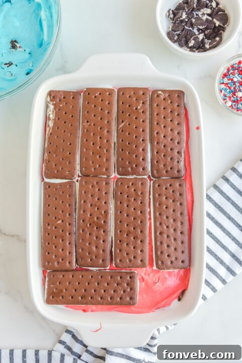 Blue food coloring being added to another portion of the cake filling.