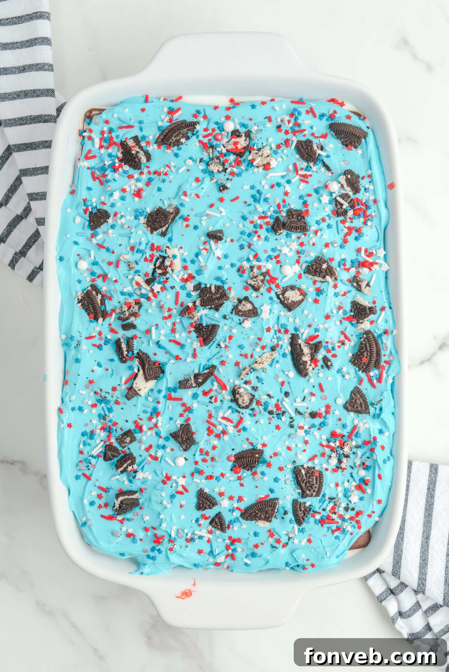 Overhead view of Patriotic Ice Cream Sandwich Cake in a white baking dish.
