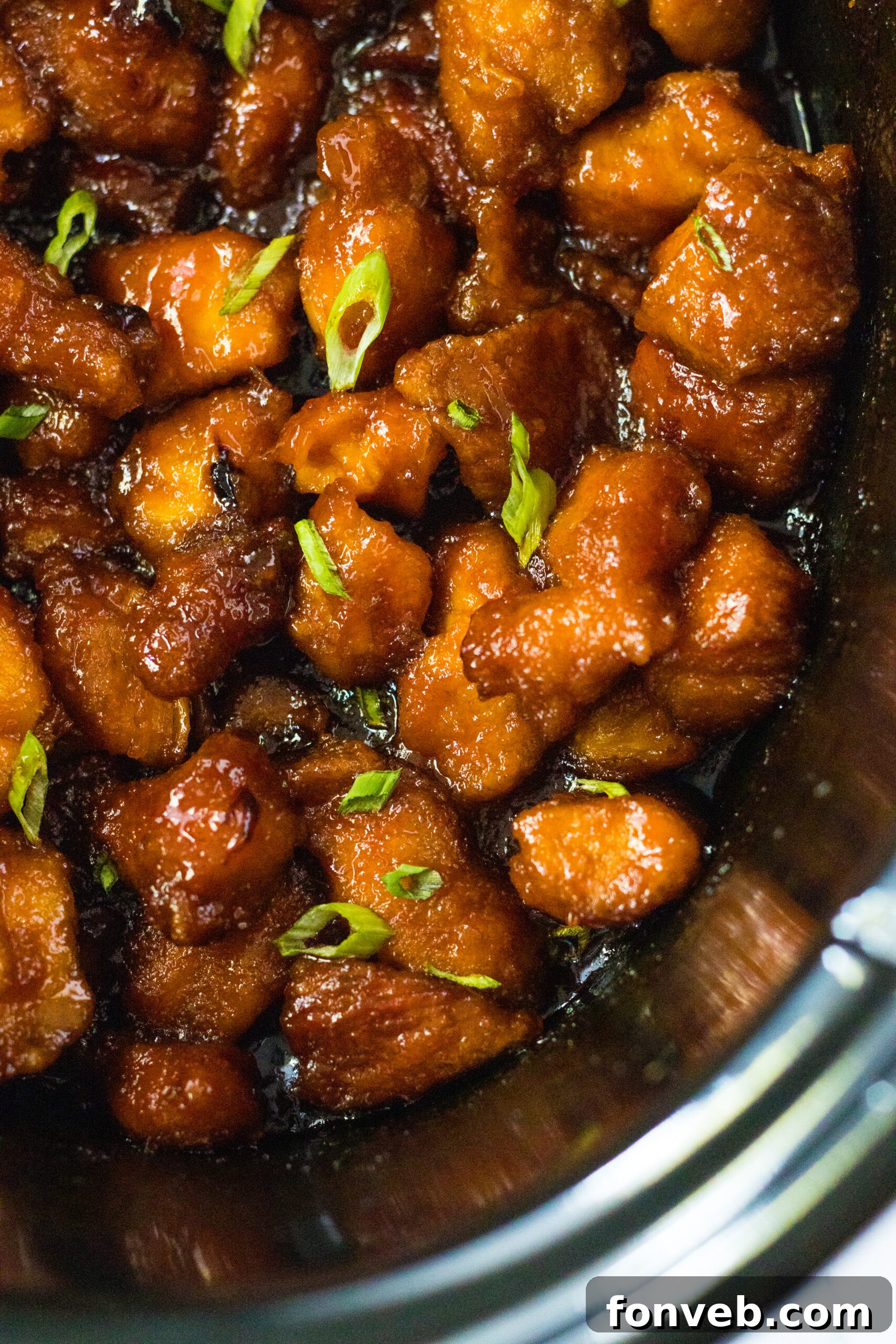 Close up view of Slow Cooker Firecracker Chicken in a crock pot, ready to be served.