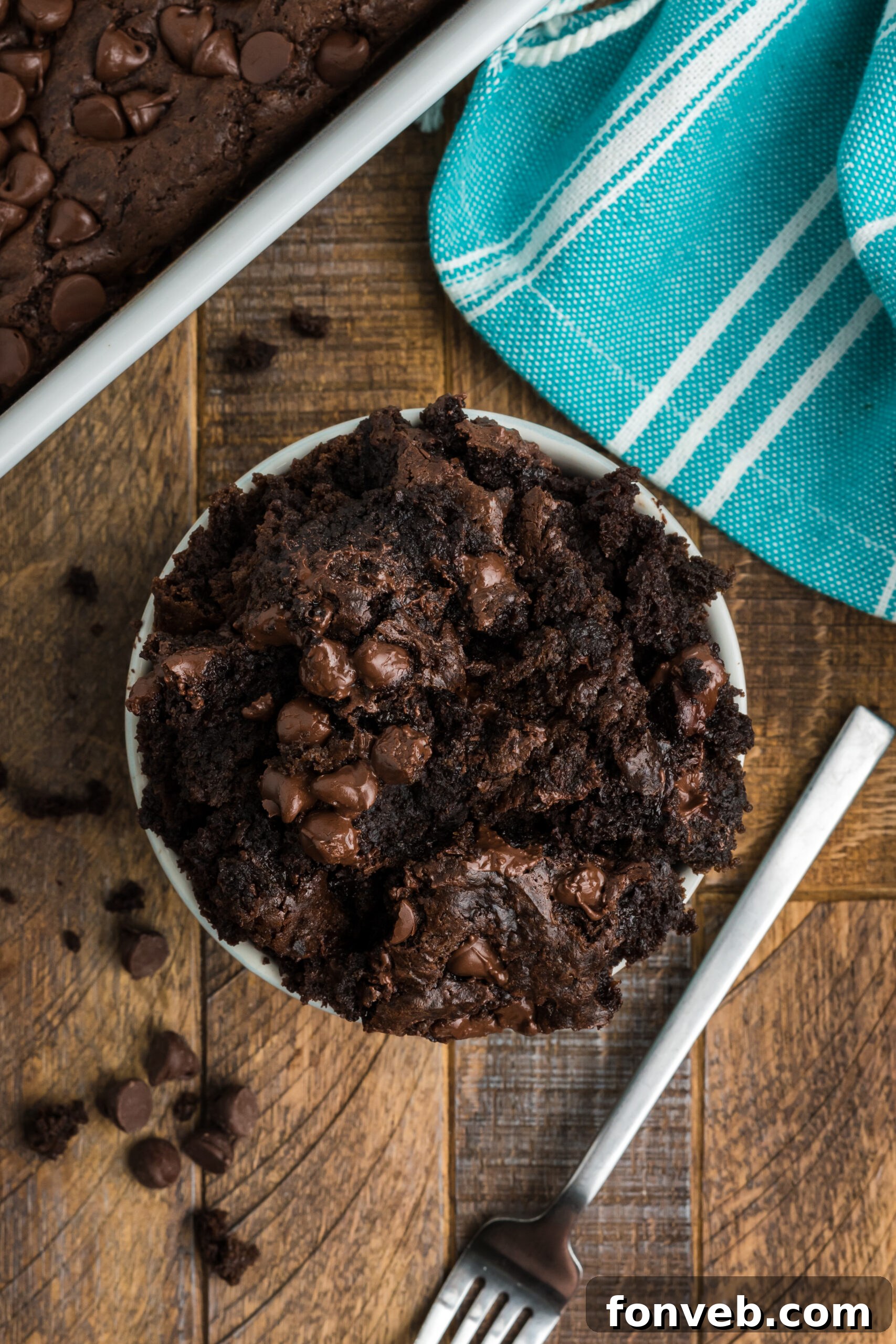 An overhead view of a single serving of chocolate dump cake in a white bowl, ready to be enjoyed.