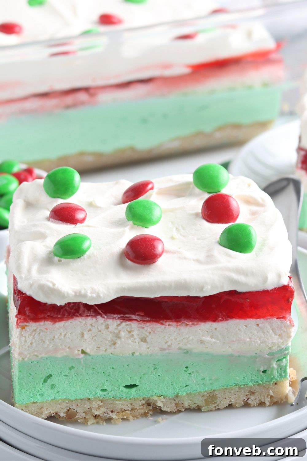 Close-up of a slice of Christmas Lasagna on a plate, highlighting its detailed layers.