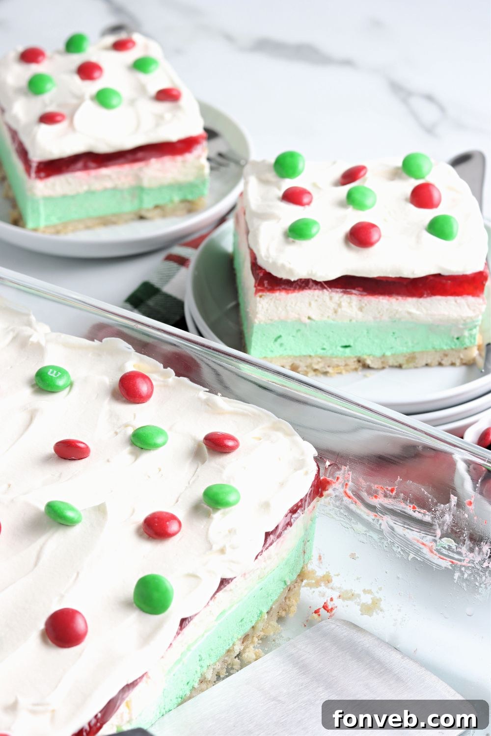 A full pan of layered Christmas dessert, showcasing the vibrant colors before slicing.