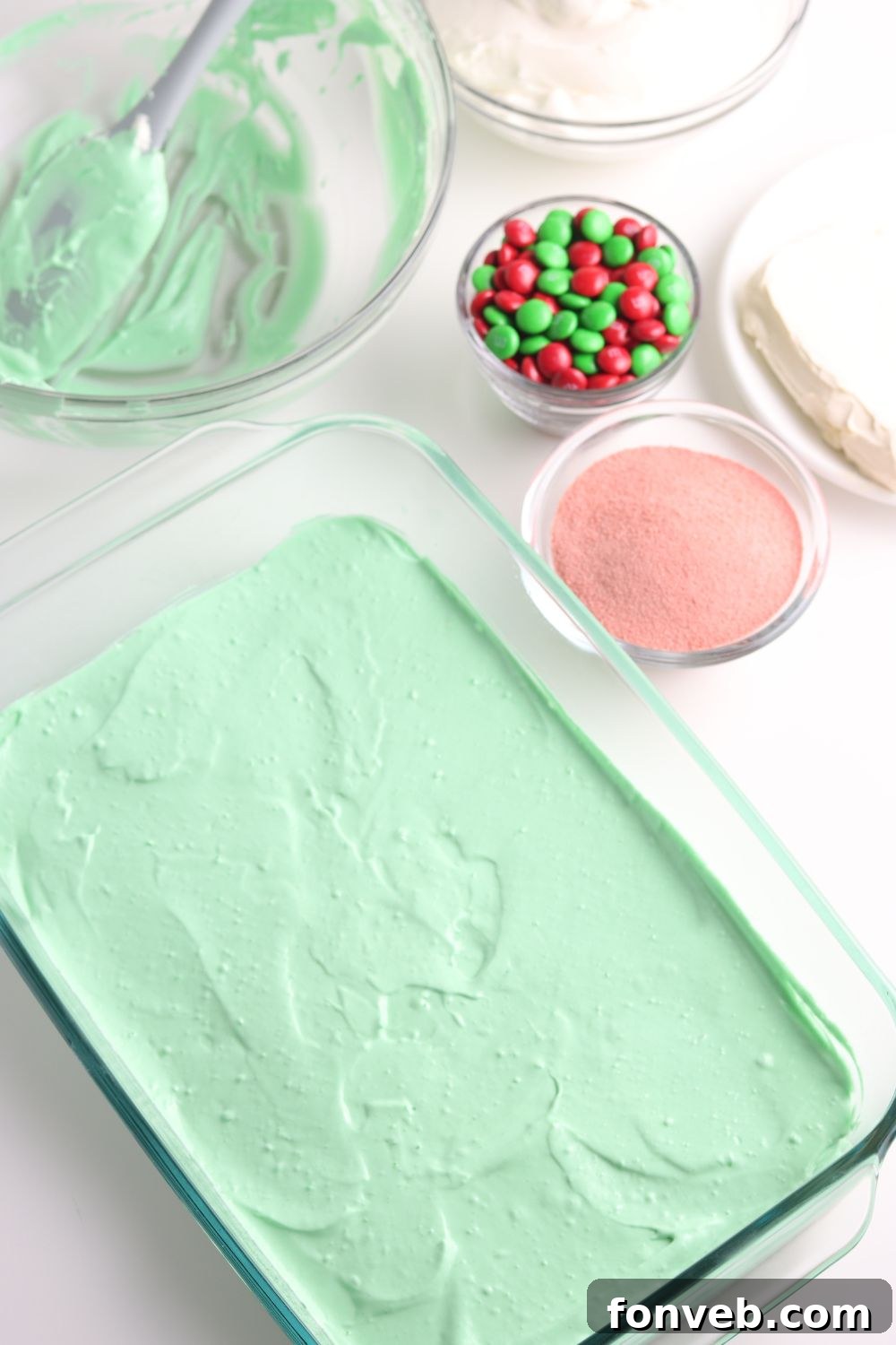 Green Jello mixture spread in a 9x13 inch baking pan over the crust.