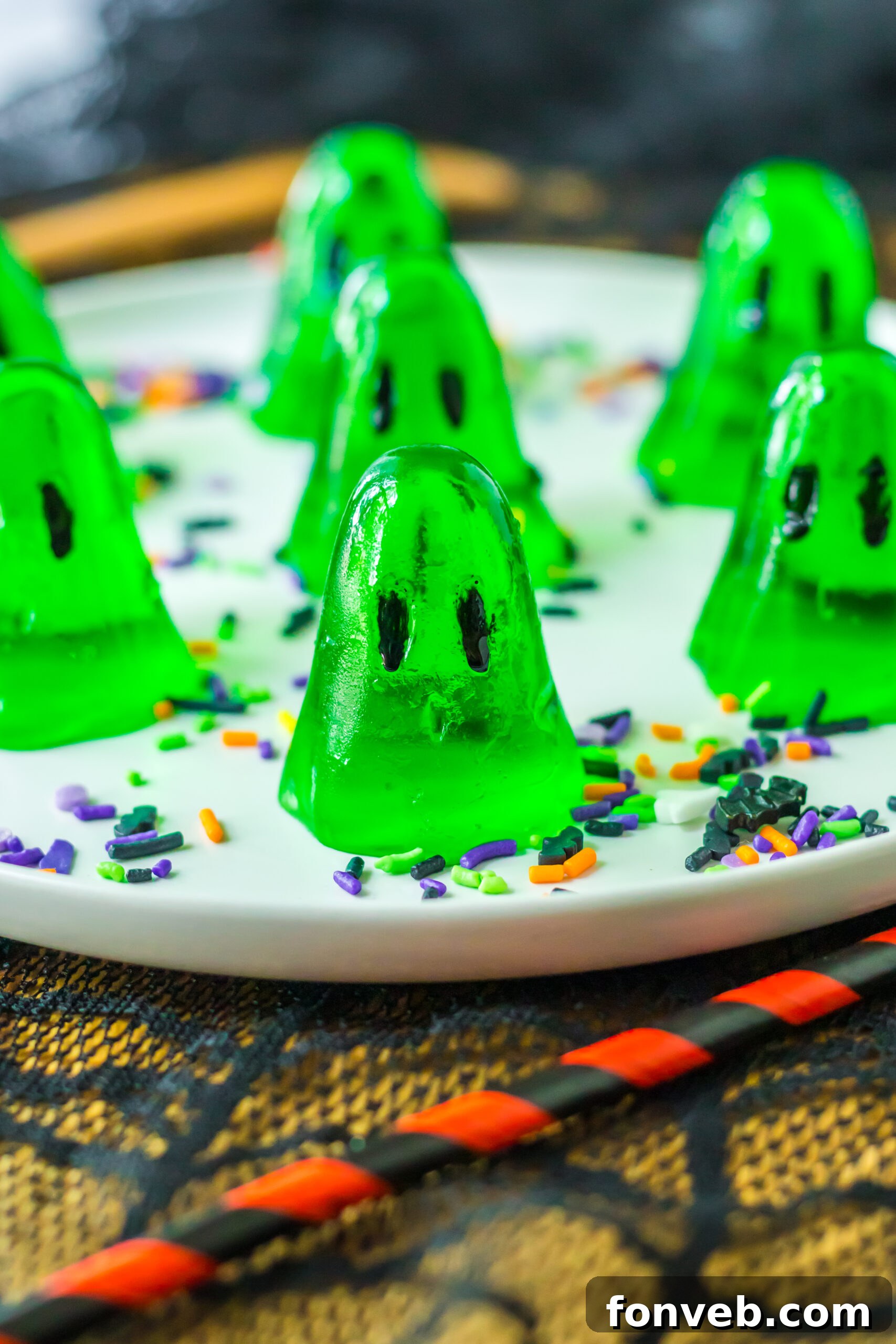 Spooky Spirit Shooters 11 A vibrant display of green ghost-shaped jello shots, ready to be enjoyed at a Halloween gathering.