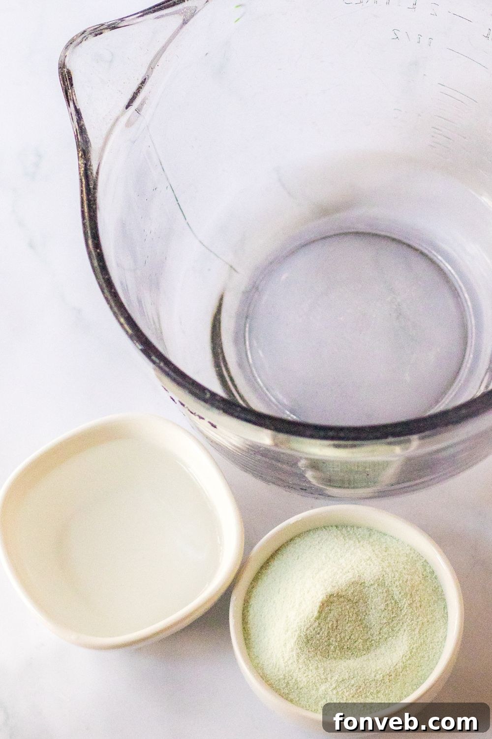 Spooky Spirit Shooters 4 A bowl containing water, jello powder, and vodka, ready for mixing to create festive jello shots.