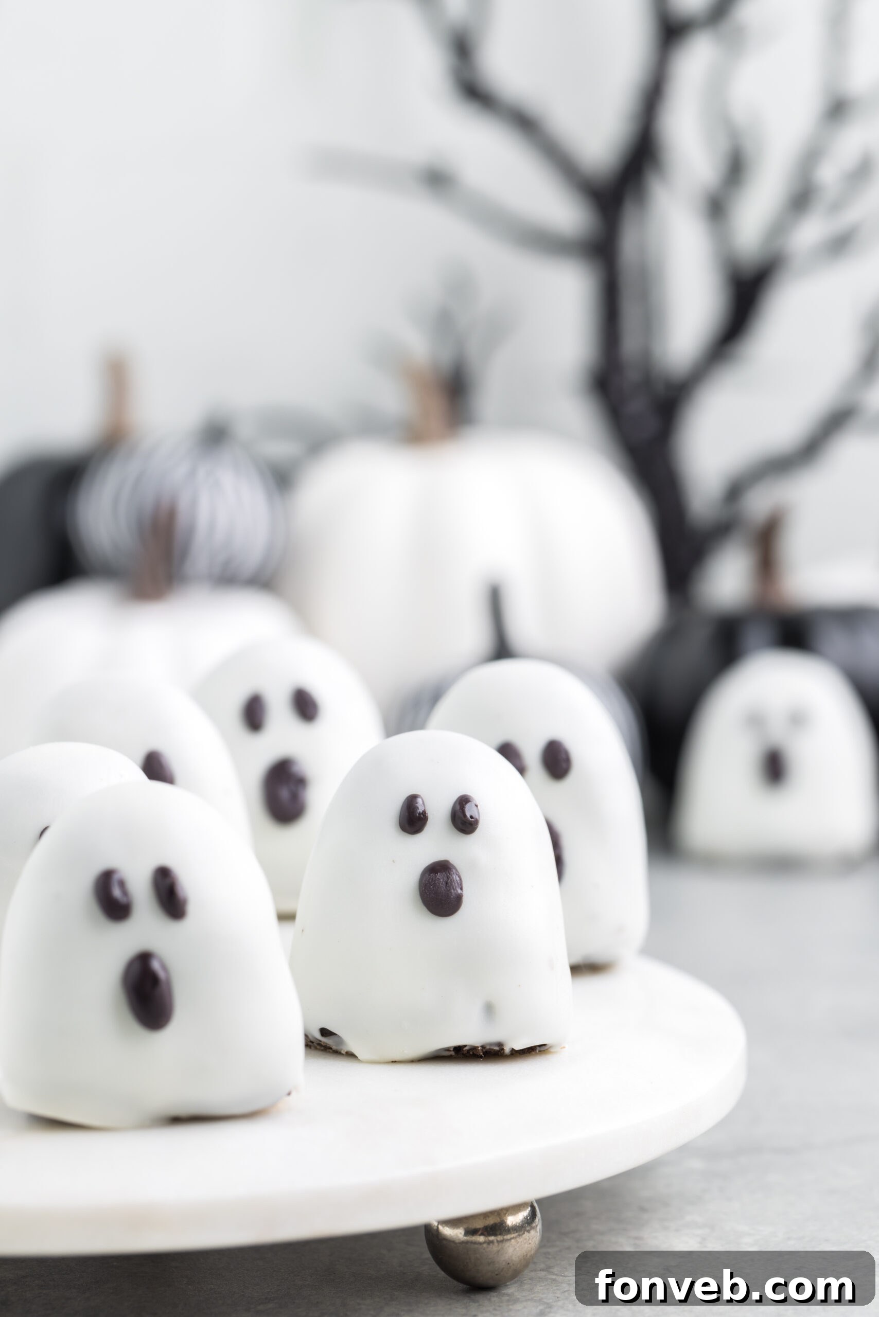 Spooky Oreo truffles on a white marble serving tray
