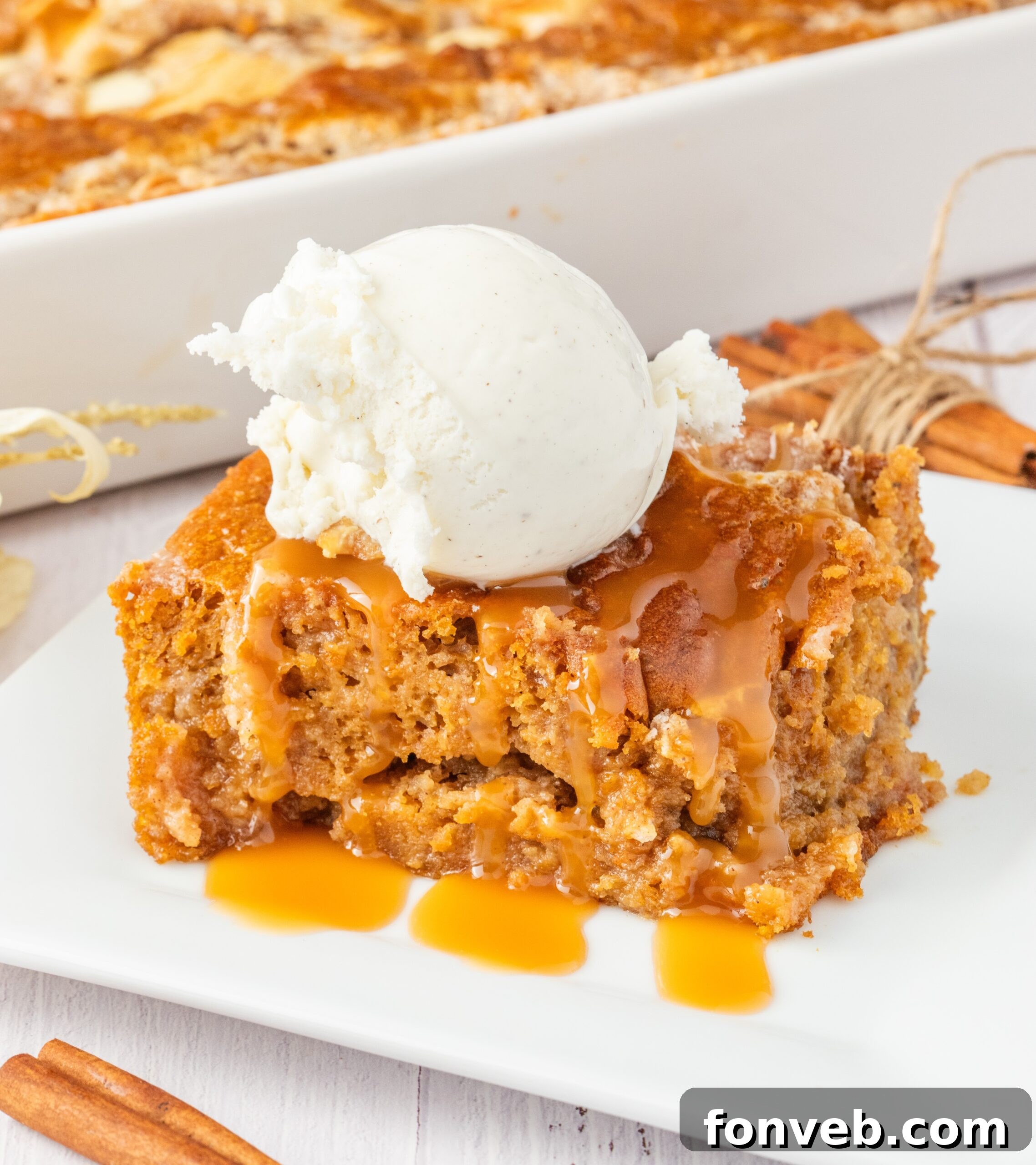 sliced earthquake cake on plate drizzled with caramel and a scoop of vanilla ice cream