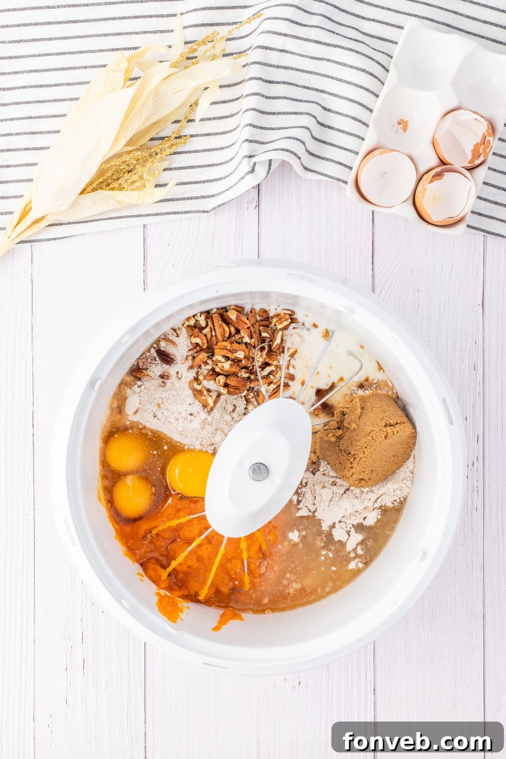 ingredients for a pumpkin cake in mixer on table