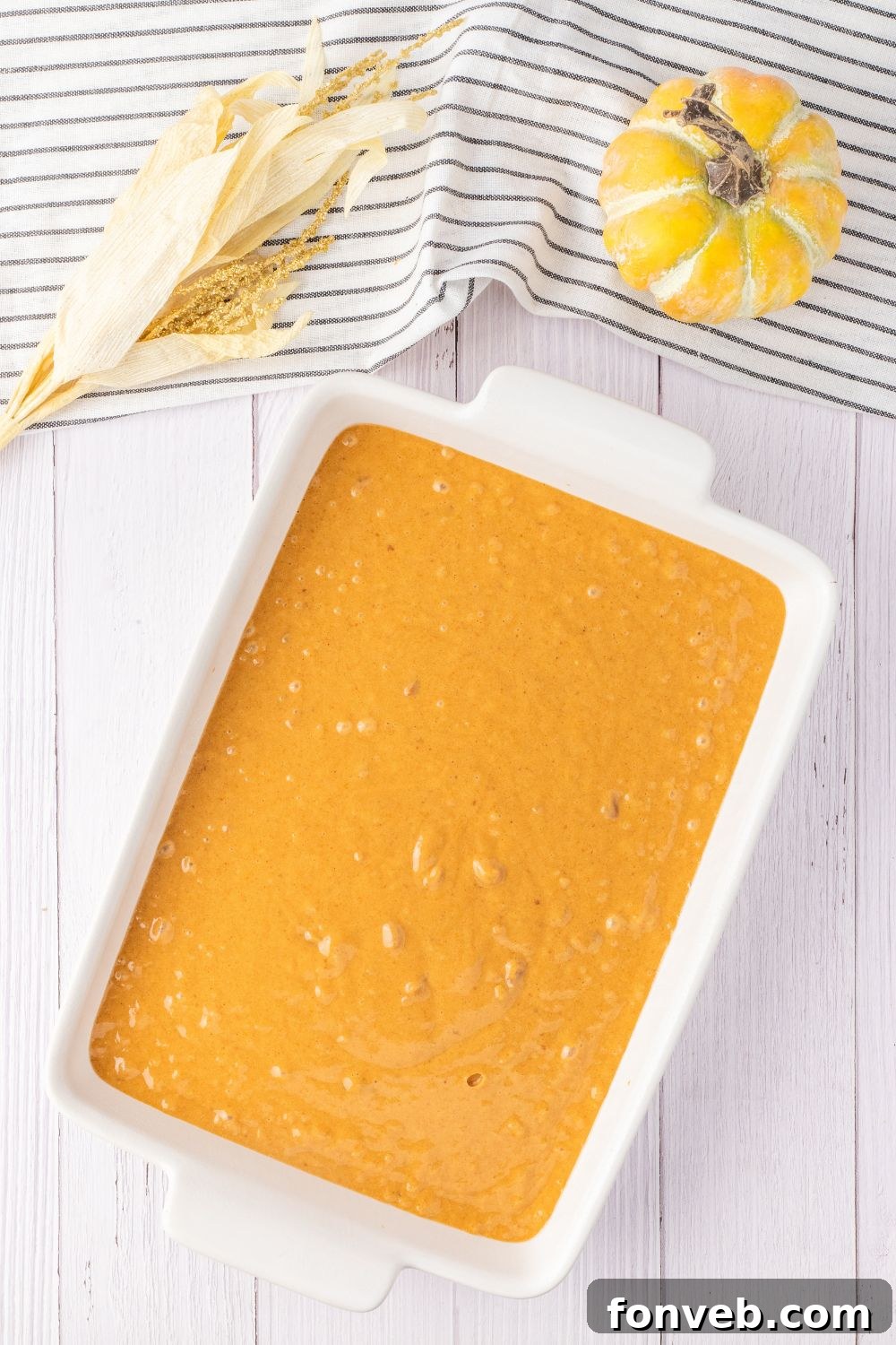 pumpkin cake batter in a baking pan