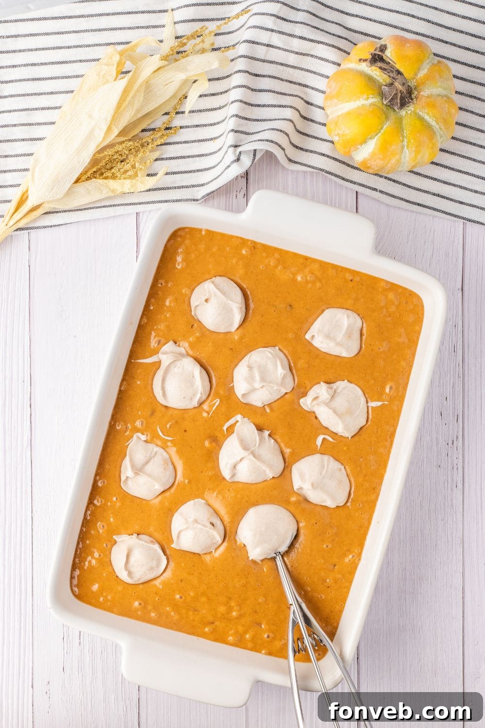 dollops of cream cheese mixture in a cake