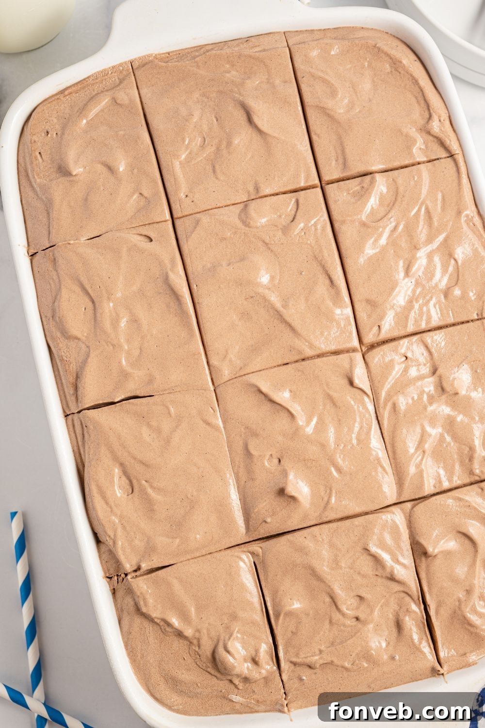 Italian Love Cake baked in a rectangular pan, neatly sliced into squares on a table.