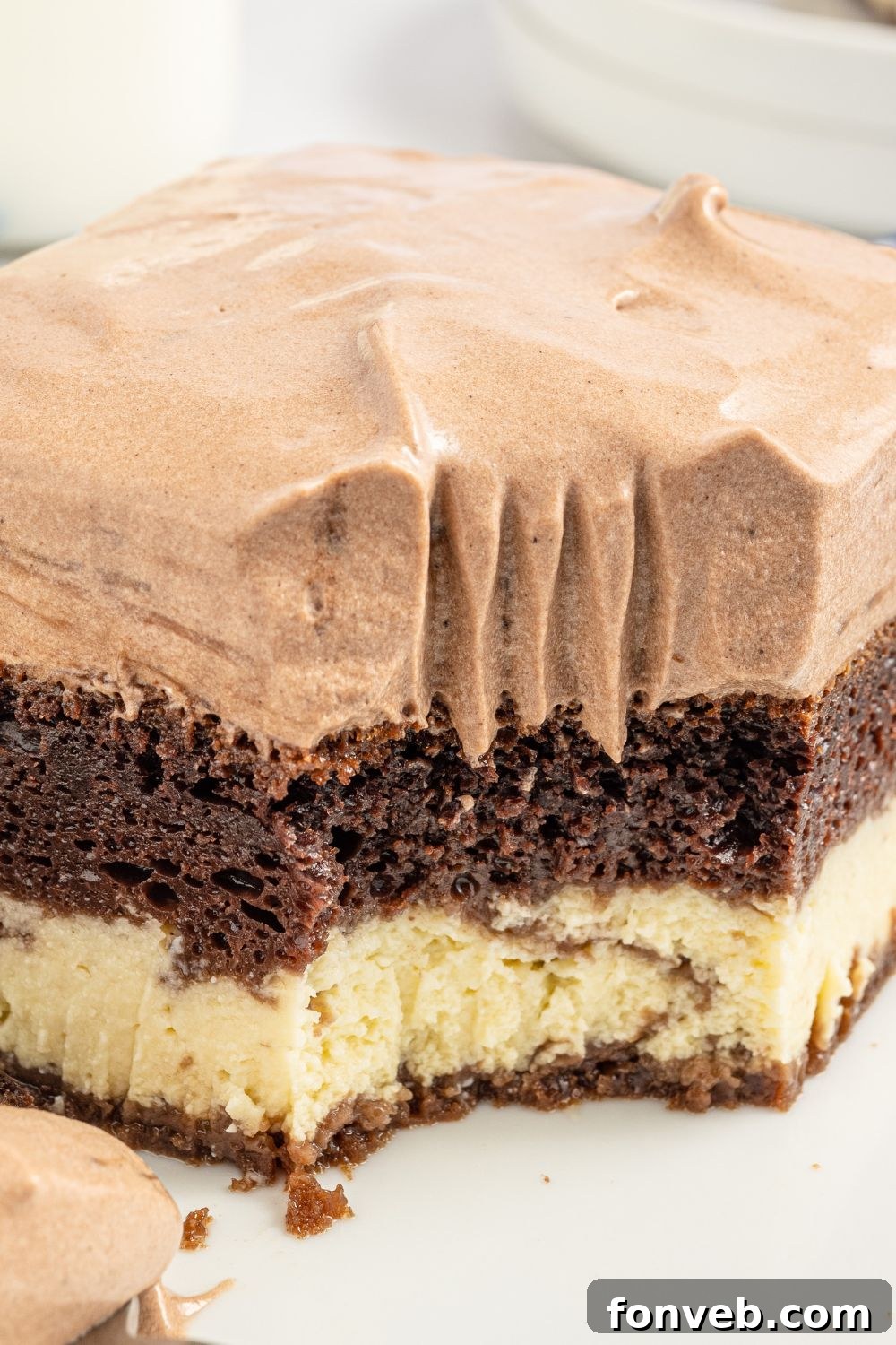An appetizing close-up of a slice of Italian Love Cake on a plate, with a fork poised to enjoy.