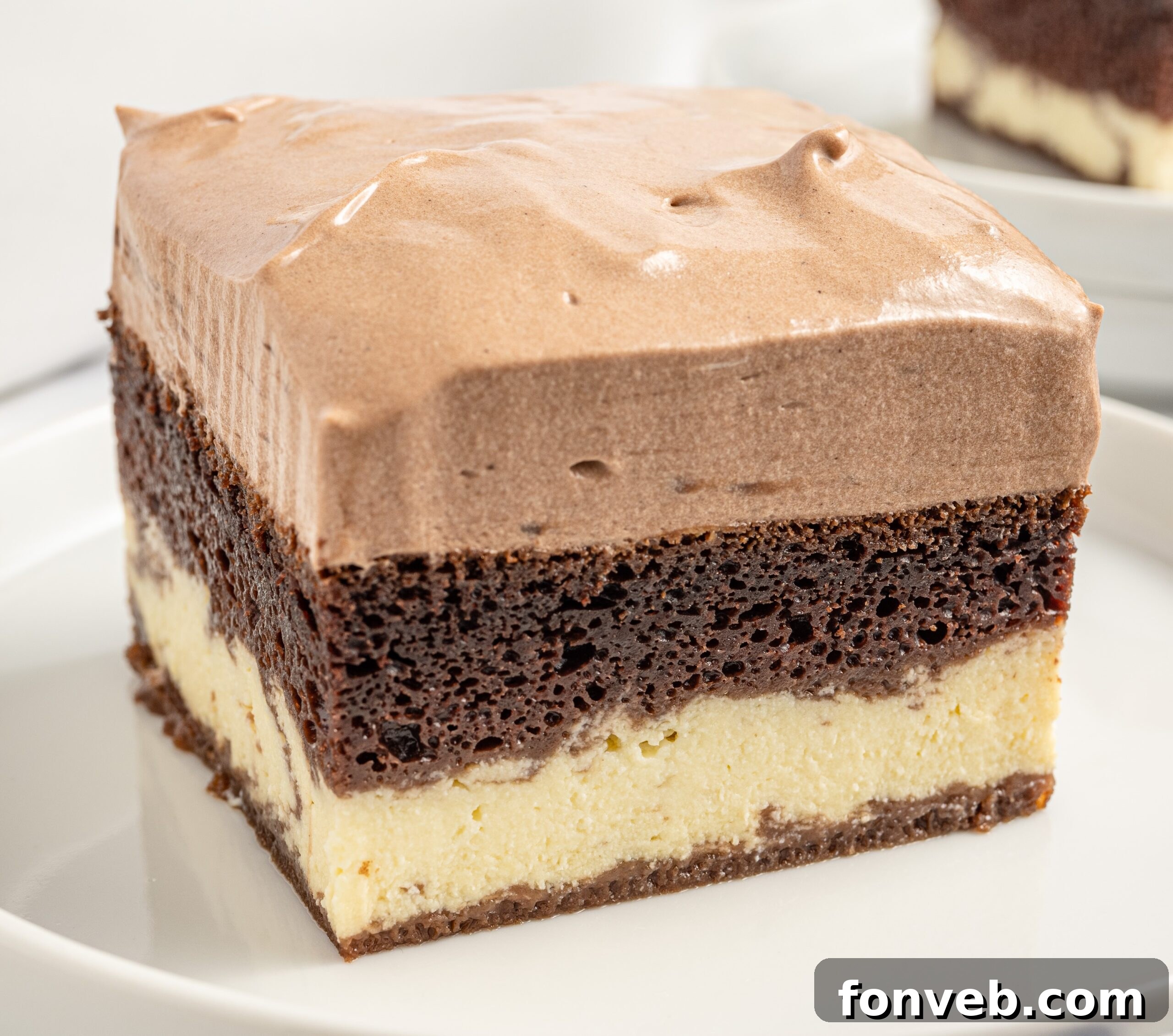 An up-close view of a slice of Italian Love Cake on a white plate, highlighting the rich chocolate and creamy ricotta layers.