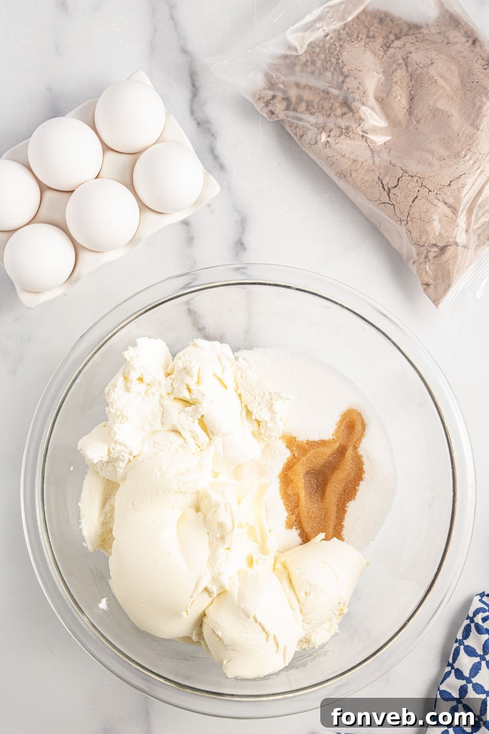 Ingredients for the ricotta layer in a clear glass bowl, showcasing the creamy texture.