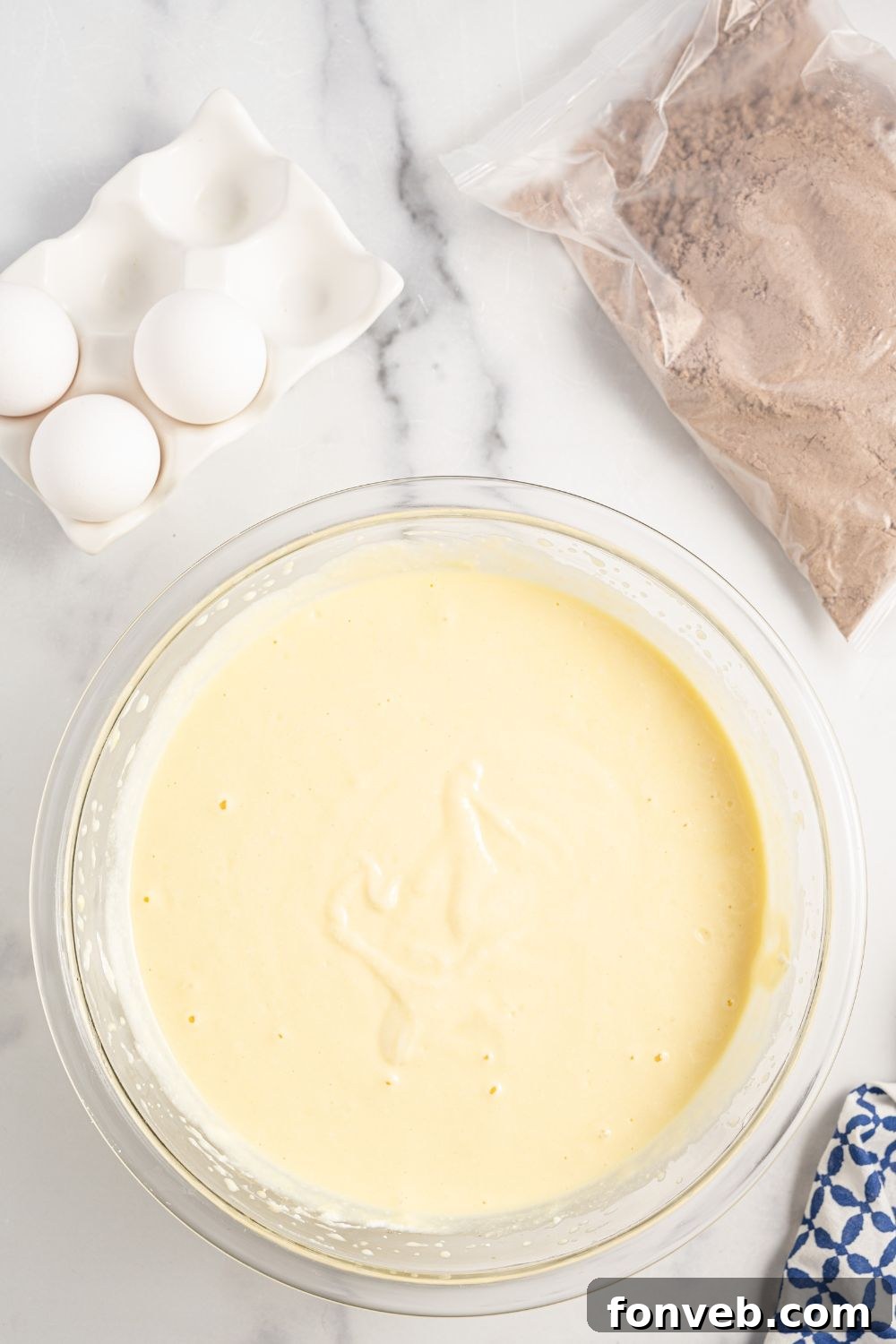 The fully mixed ricotta batter in a glass bowl, ready for layering.