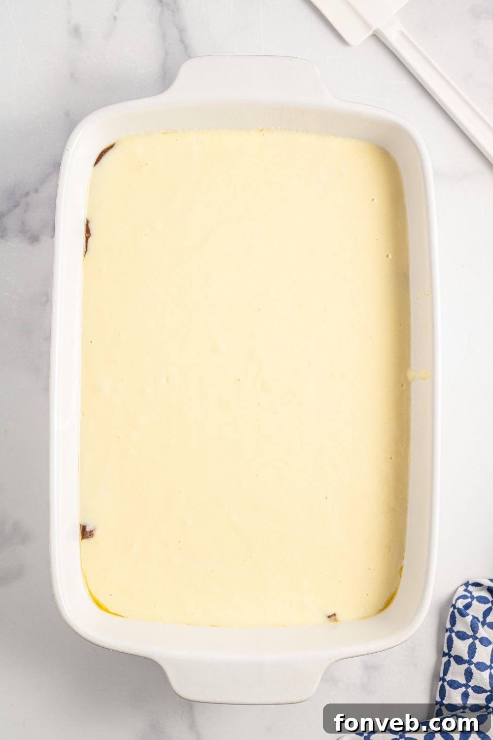 The ricotta batter carefully poured into a 9x13 baking dish over the chocolate cake layer.