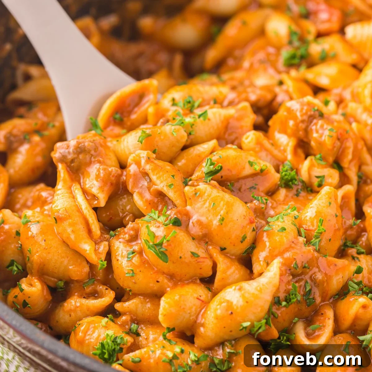 taco pasta in a pan with a wooden spoon
