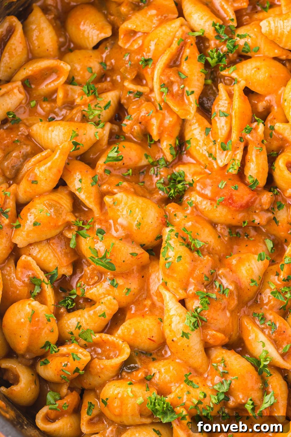 overhead shot of cheesy taco pasta in a skillet on the stove