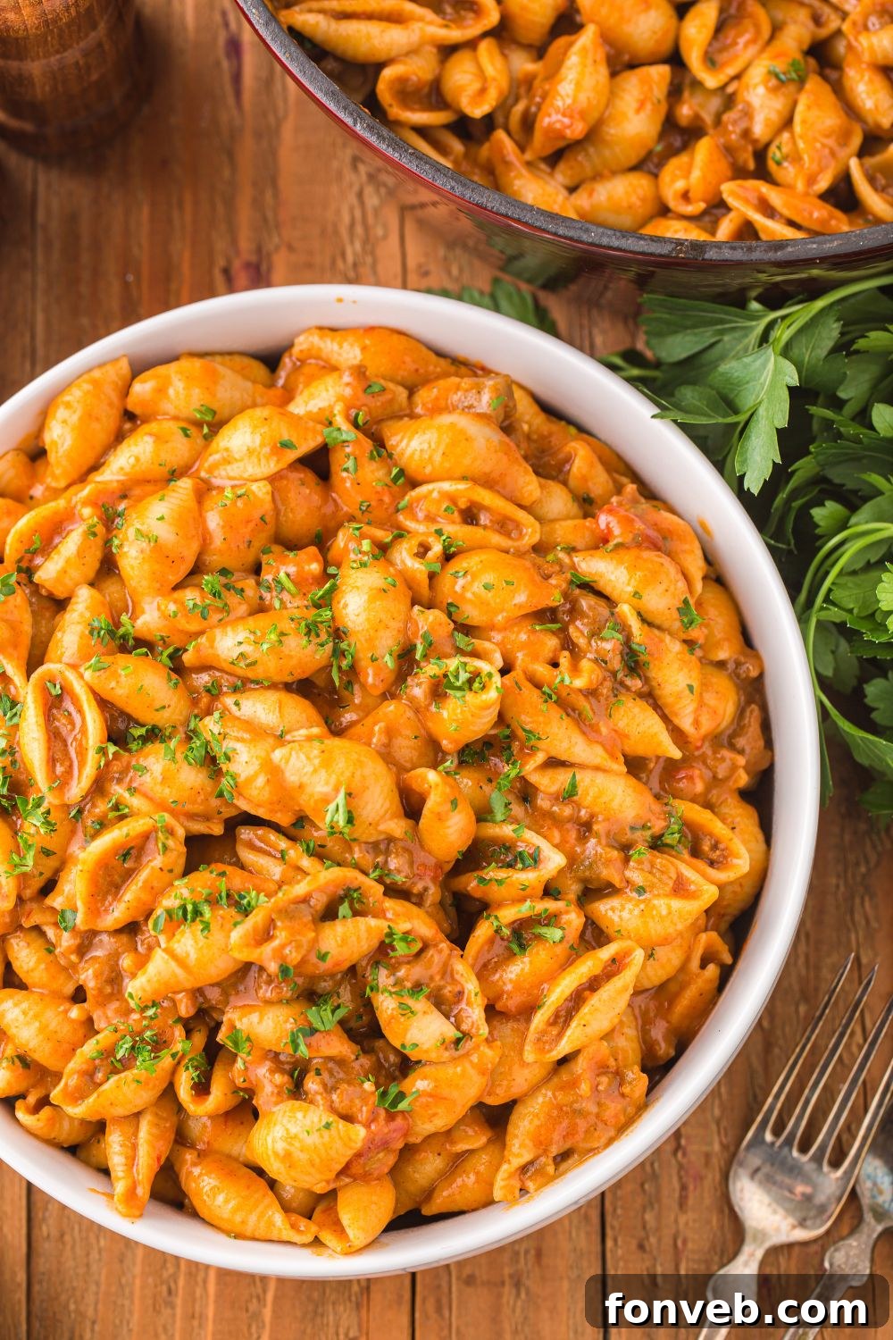 bowl with taco pasta in it and a skillet in the background 