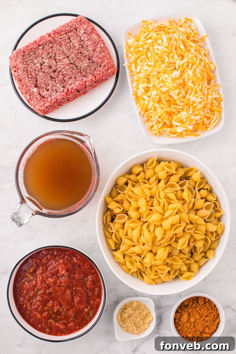 ground beef, pasta, and more in bowls on counter