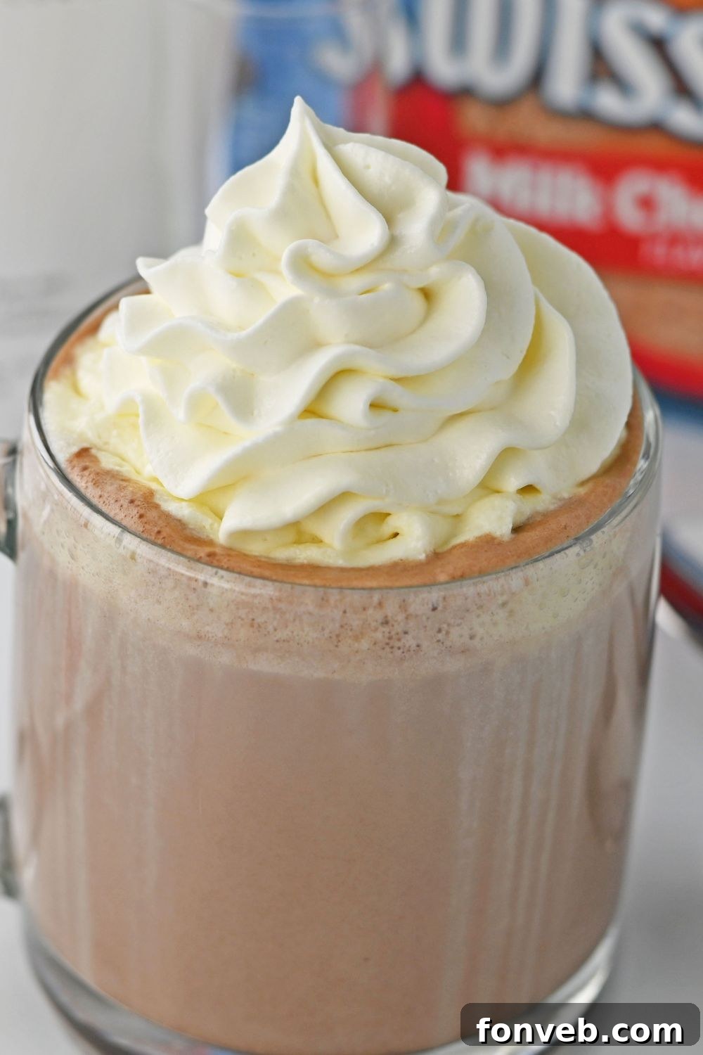 RumChata and hot chocolate mixture in a clear glass, ready to be topped with whipped cream