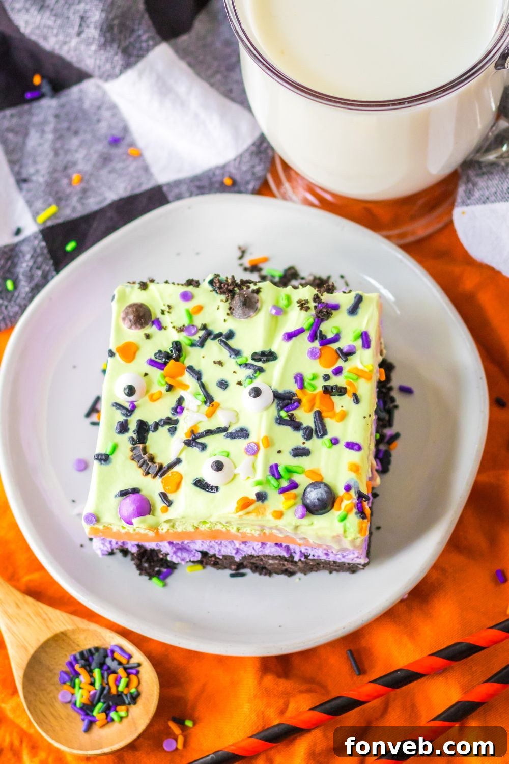 plate with a slice of halloween cake on it with sprinkles in plate on side 