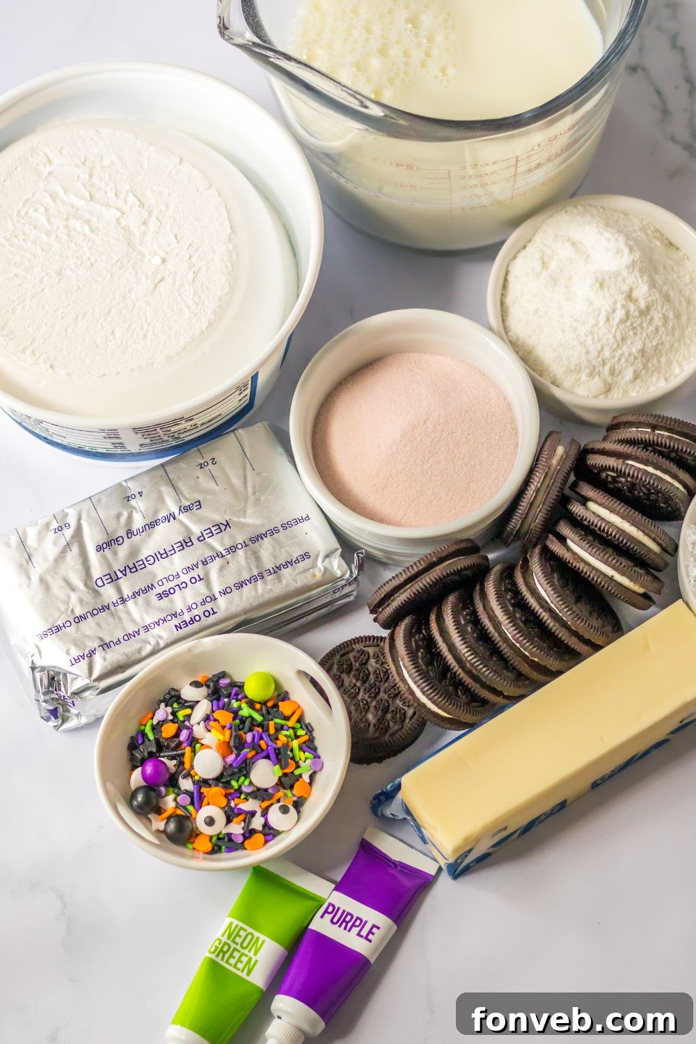 cream cheese layered dessert ingredients on a marble counter