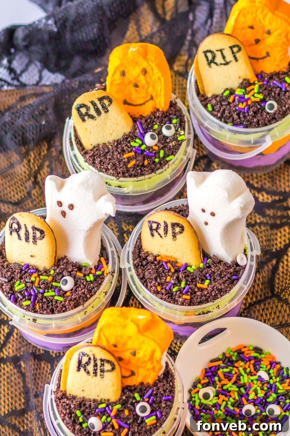 Monster Mash Pudding Treats 3 halloween pudding cups in containers on table with a bowl of sprinkles beside it