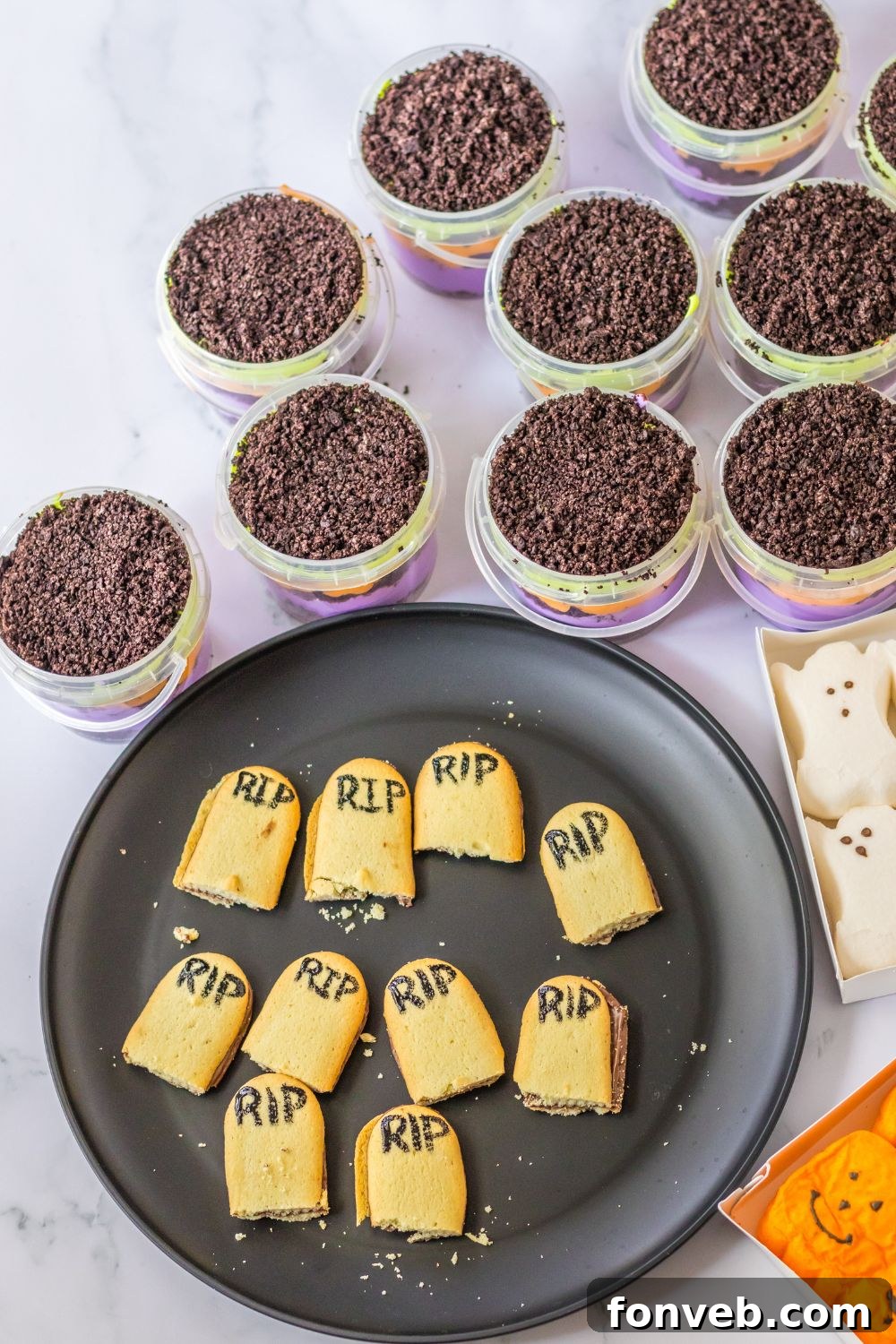 Monster Mash Pudding Treats 10 milano cookies broken in half and RIP written in food coloring on them