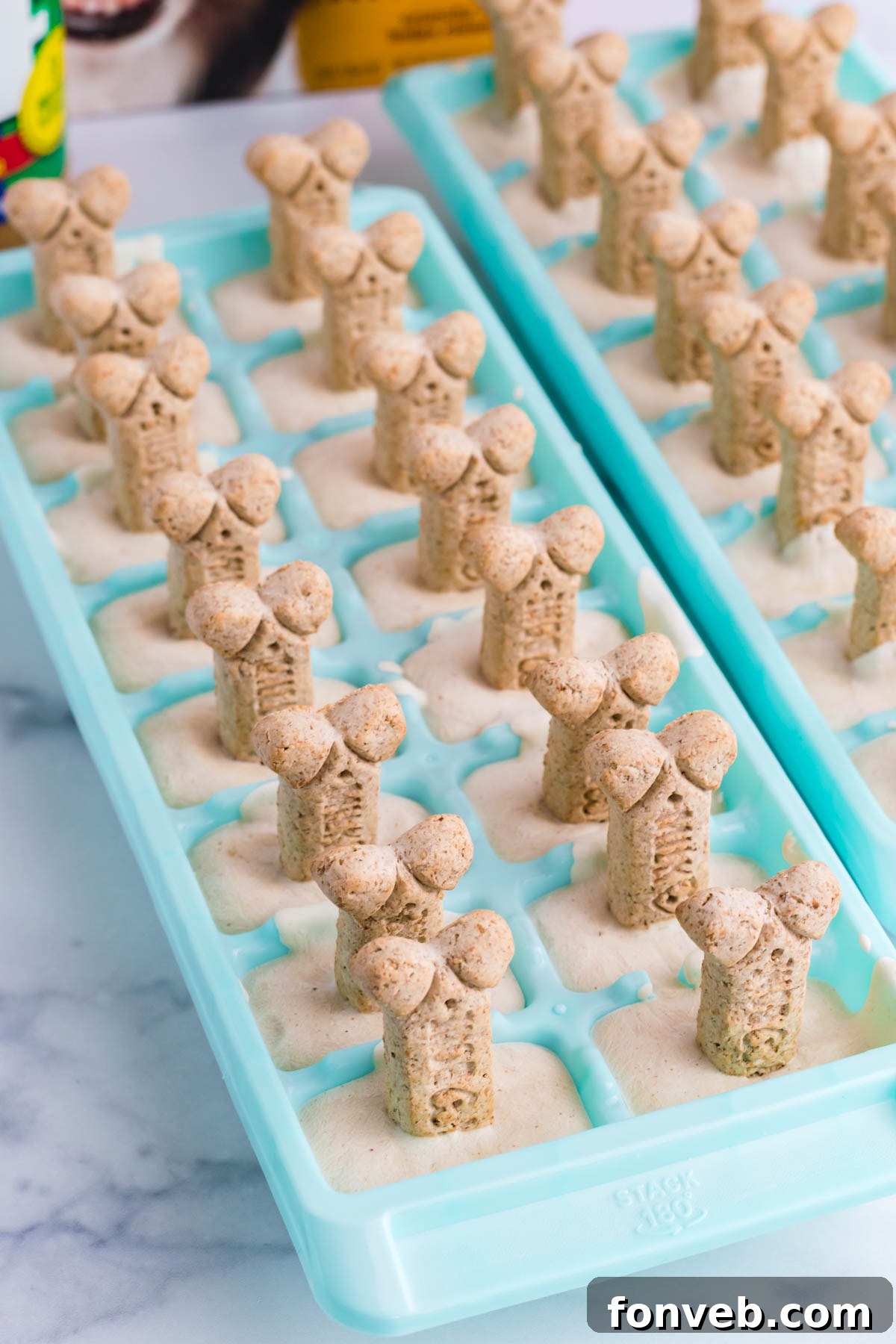 pup ice cream in a blue ice cube tray on a marble table
