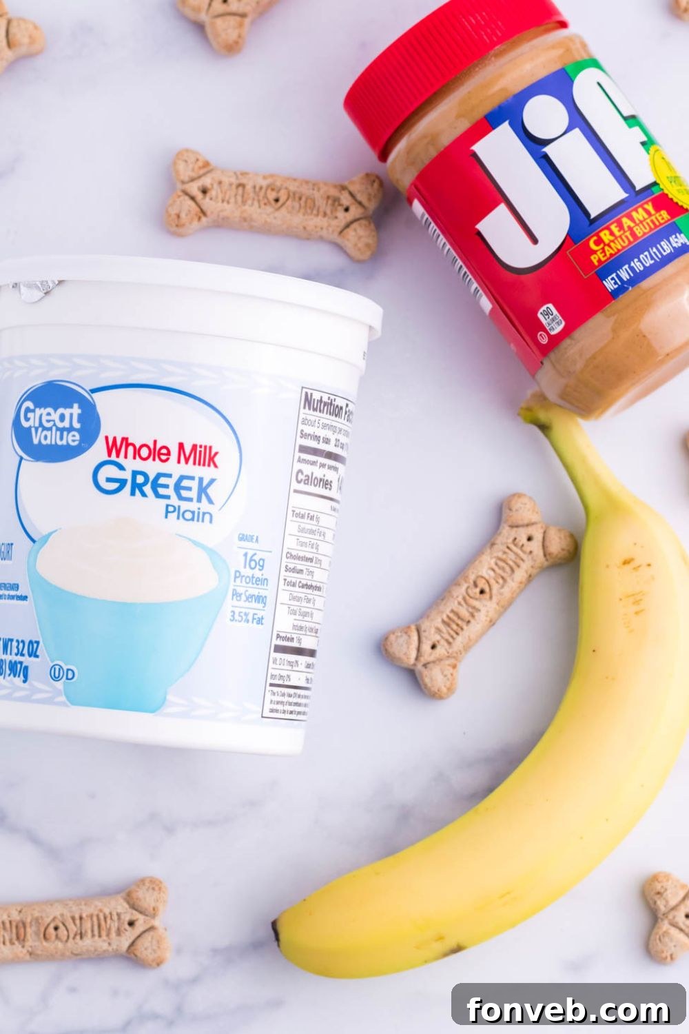 ingredients for making a peanut butter popsicle for dogs on a white table