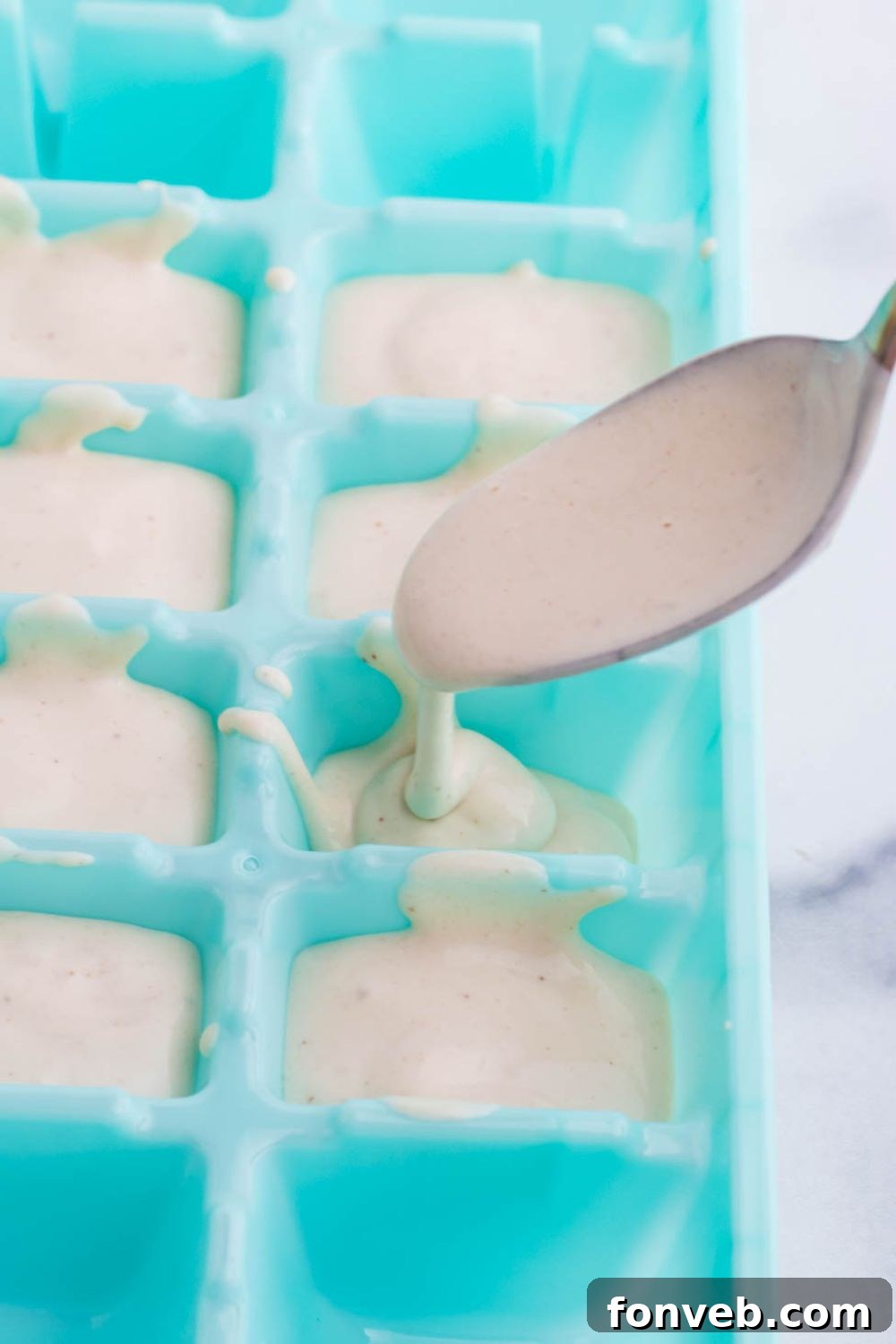 spooning dog ice cream into mold 