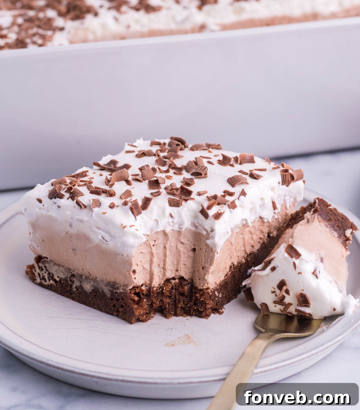 French Silk Brownies with fork bite taken out on a white plate