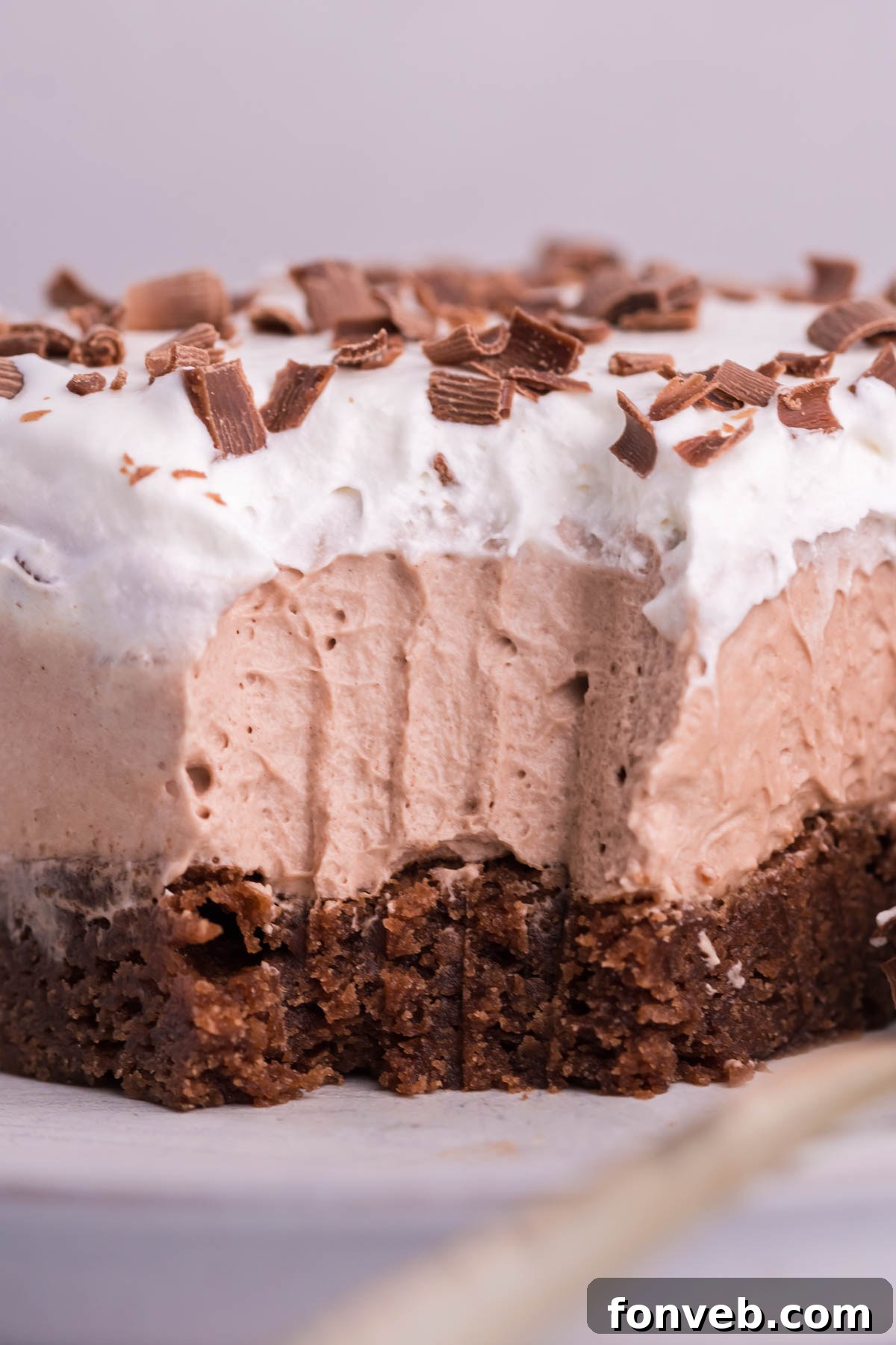 Up close shot of the French Silk Brownies with fork bite taken out on plate