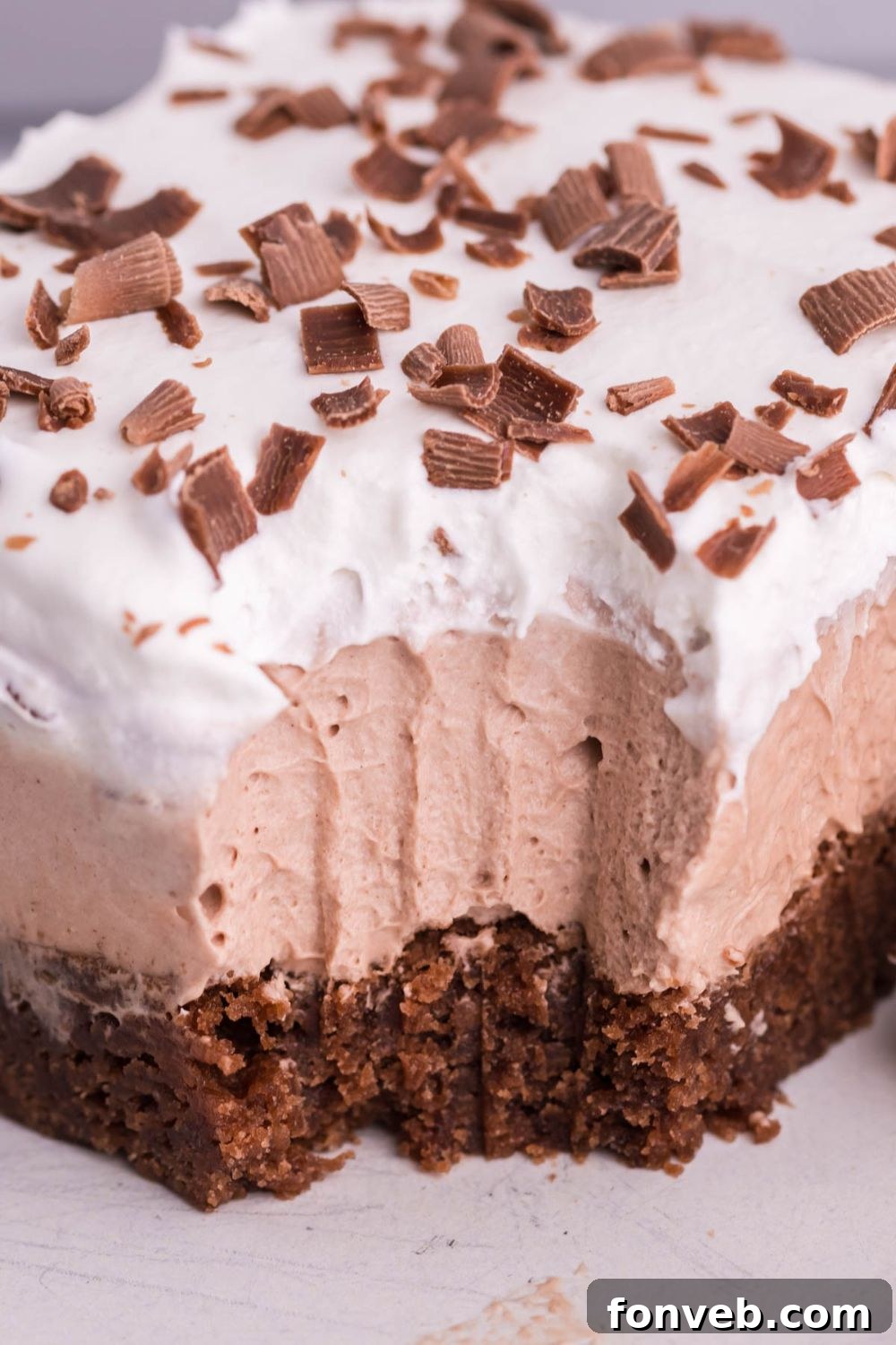 French silk pie brownie with bite taken out of it sitting on plate