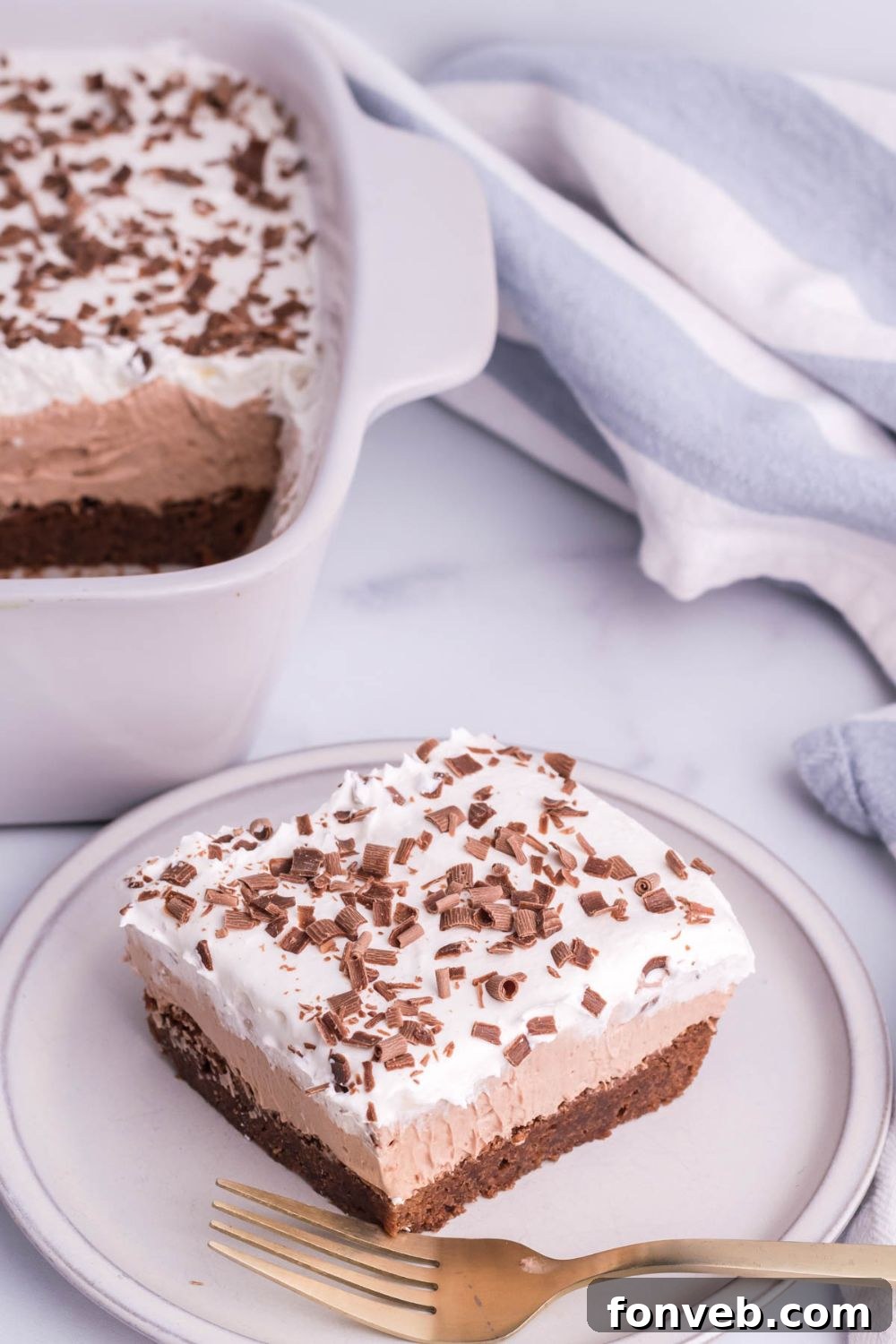 French Silk Brownie in pan and then a sliced brownie on plate on counter 