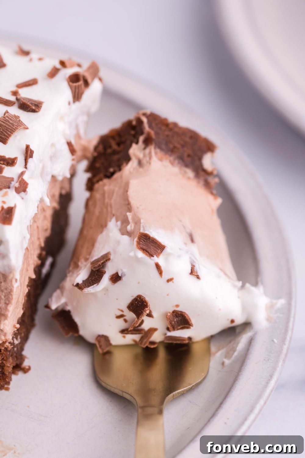 French silk pie with a fork bite taken out sitting on plate