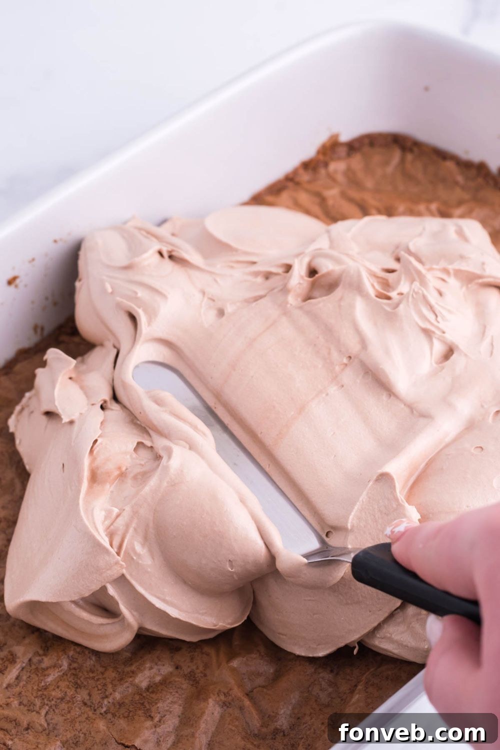 spreading french silk pie filling over the top of the brownies 