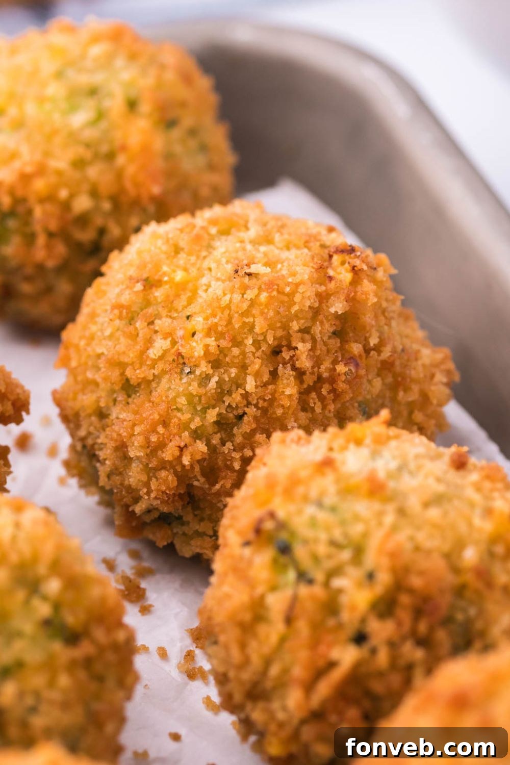 Crispy Fried Broccoli Poppers 12 lined broccoli bites on a tray