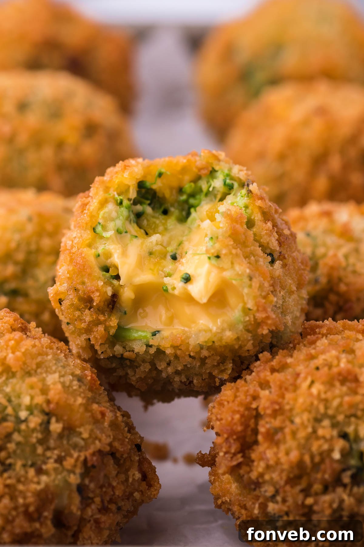 Crispy Fried Broccoli Poppers 3 Broccoli Cheese Bites with a bite missing