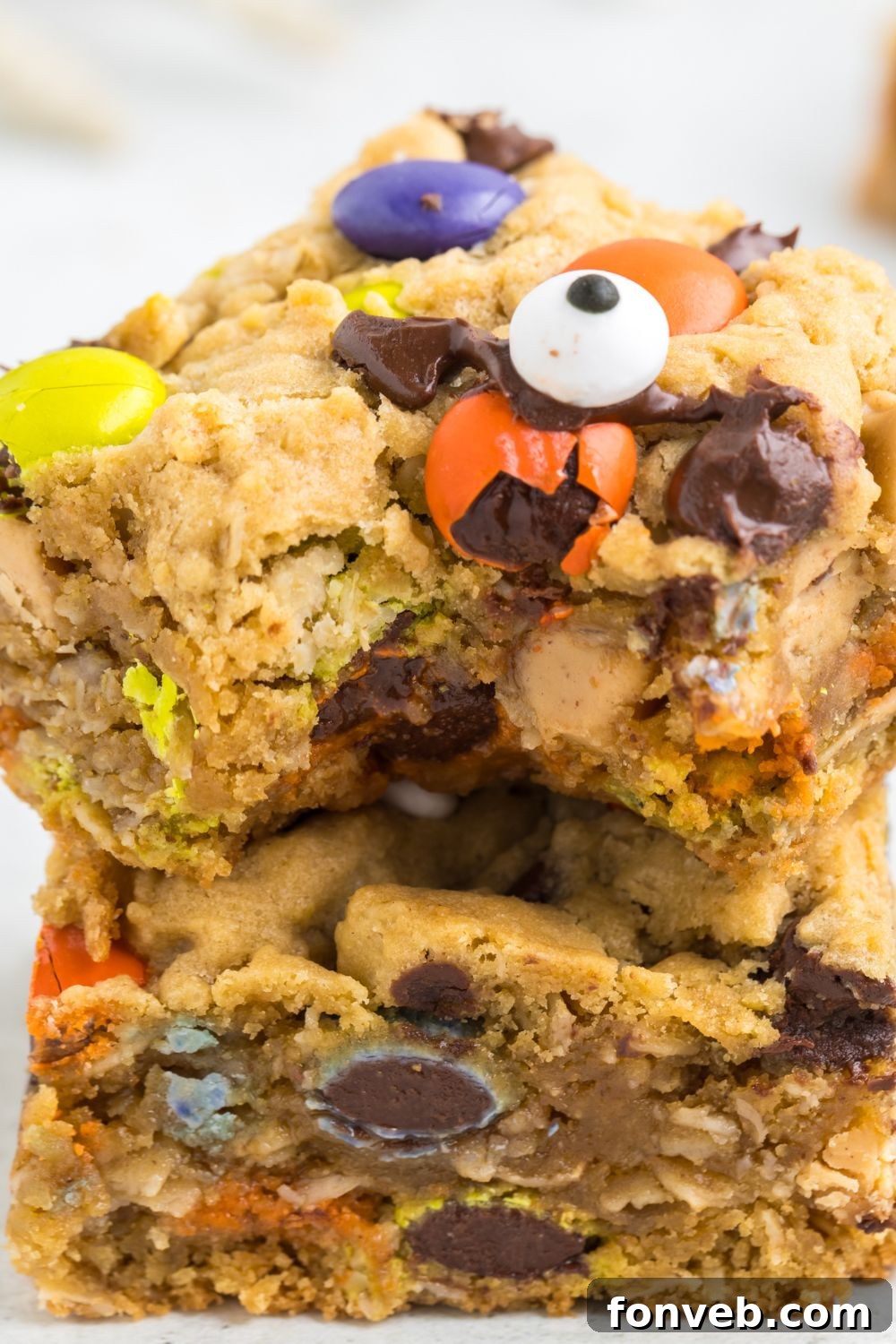 Multiple stacked cookie bars on a table, highlighting their inviting texture and generous size.