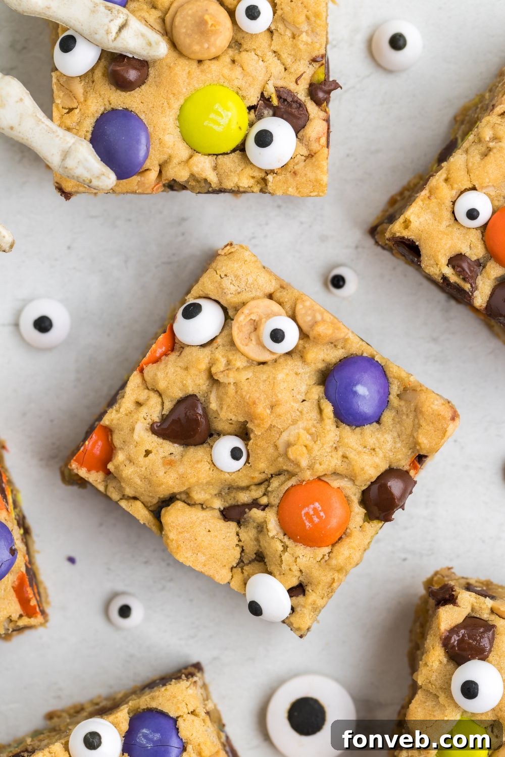 Sliced cookie bars artfully arranged on a table with decorative candy eyes scattered around, creating a Halloween theme.