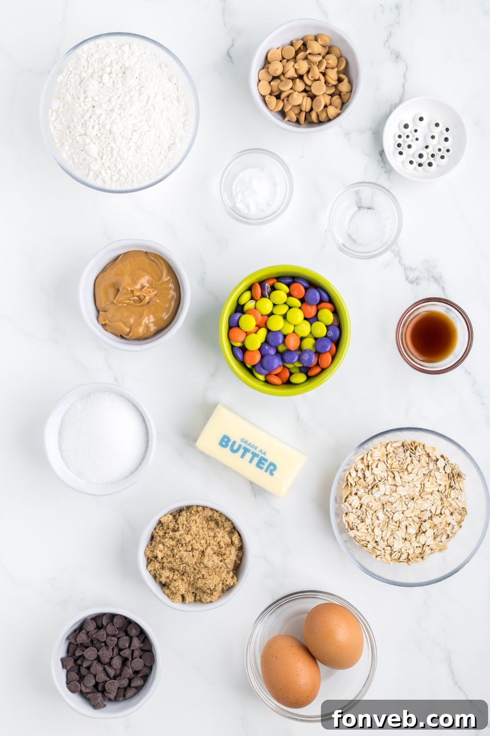 Various ingredients for monster cookie bars, neatly laid out in clear glass bowls on a table.