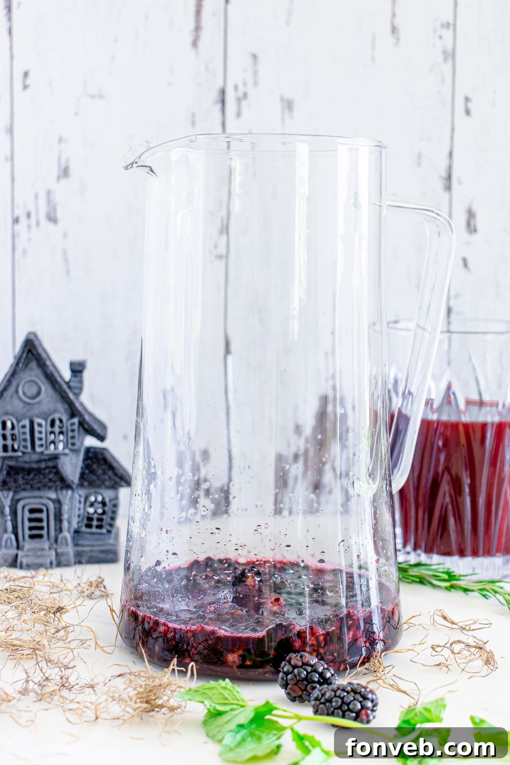 Magic Potion Margarita 7 Muddled blackberries in the bottom of a glass, ready for cocktail preparation.