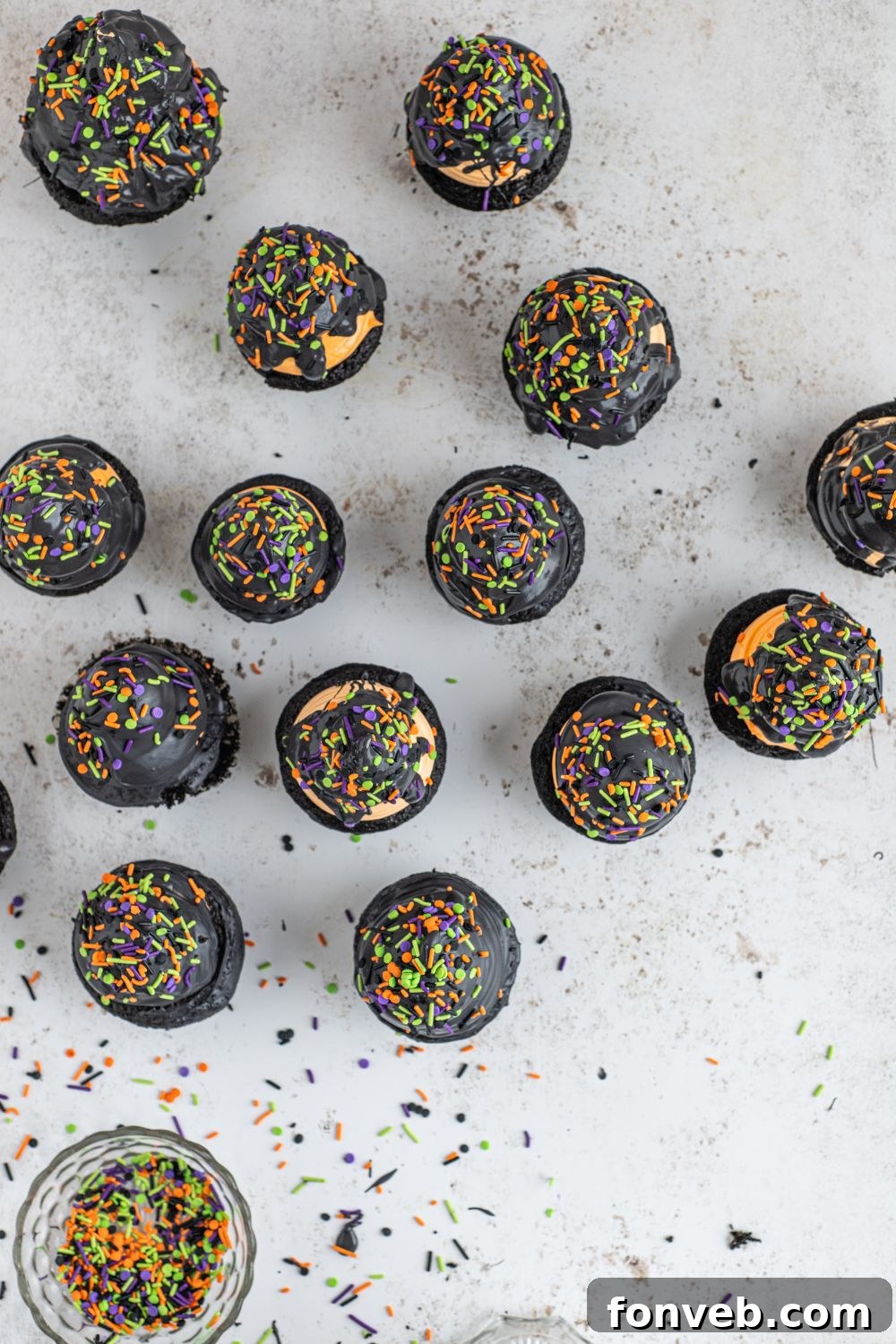 Finished Halloween Cupcakes on a marble counter, showcasing their final decoration.
