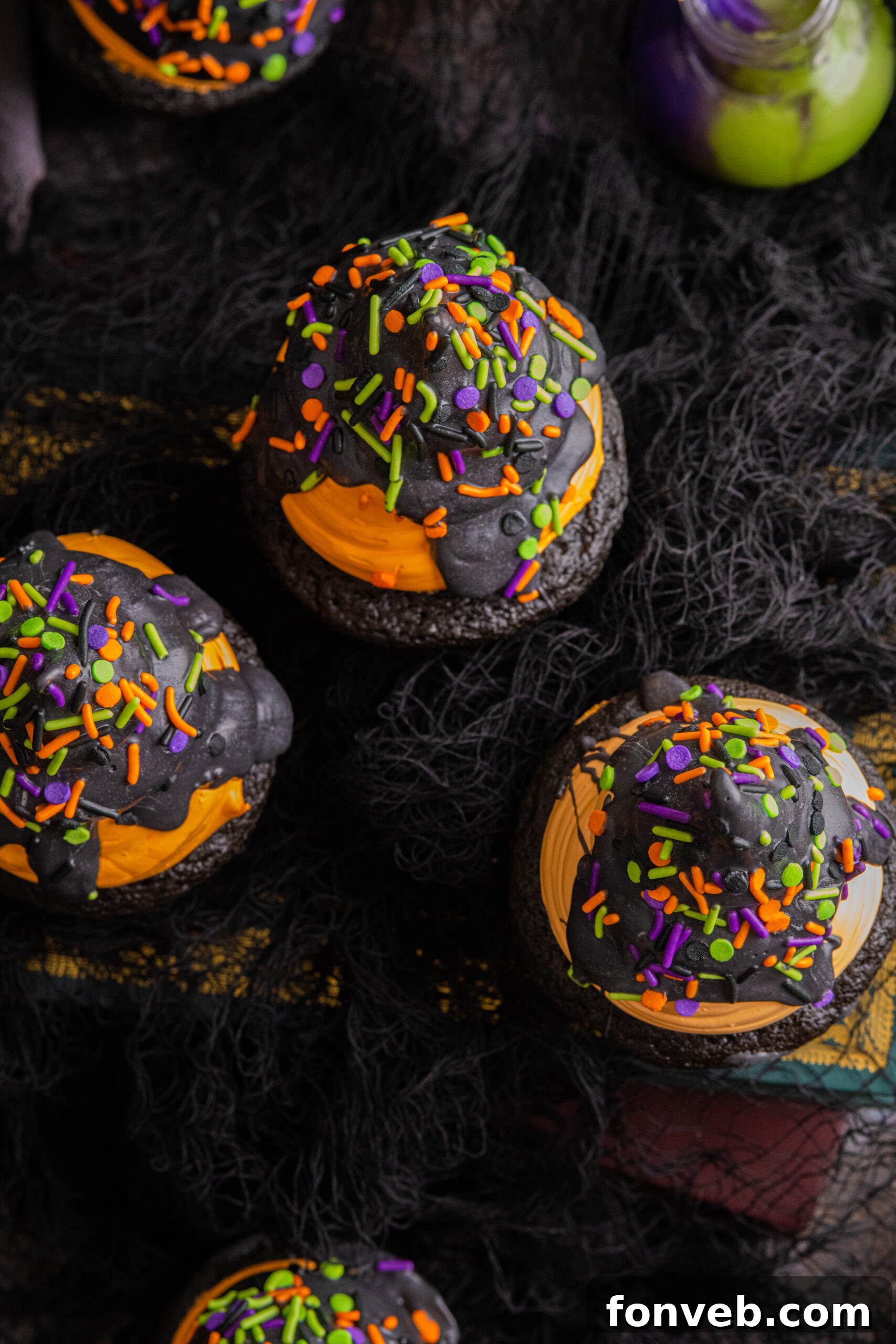 Halloween cupcakes on table with an overhead shot to see the frosting on each cupcake, showing the full spread.
