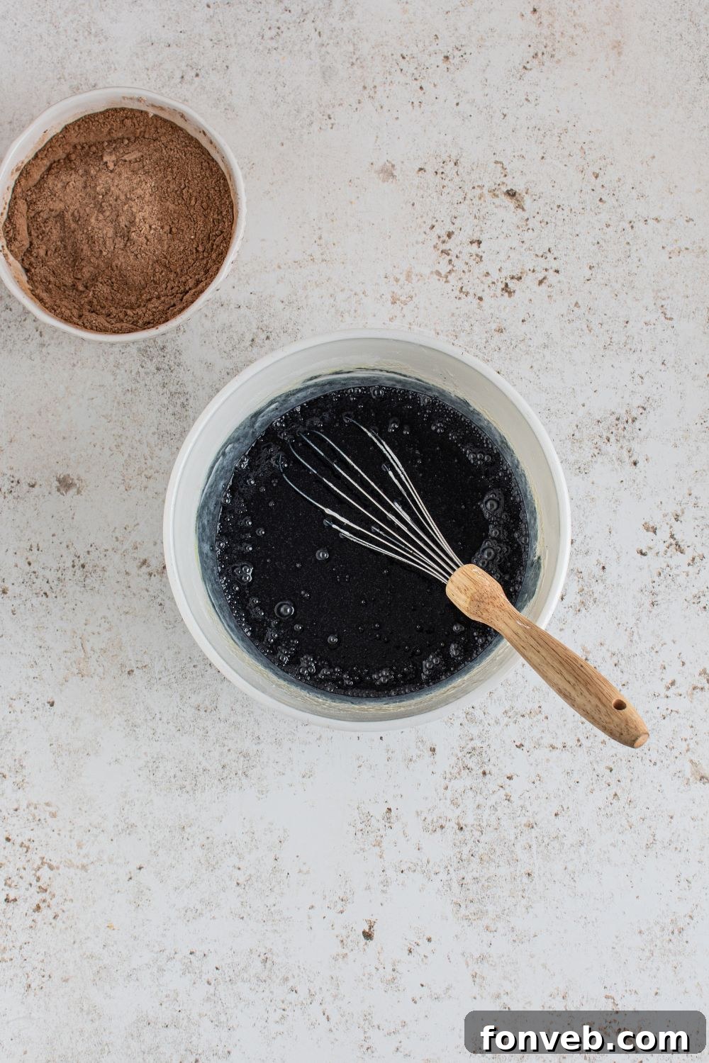 Black colored cupcake batter ready to be spooned into liners.